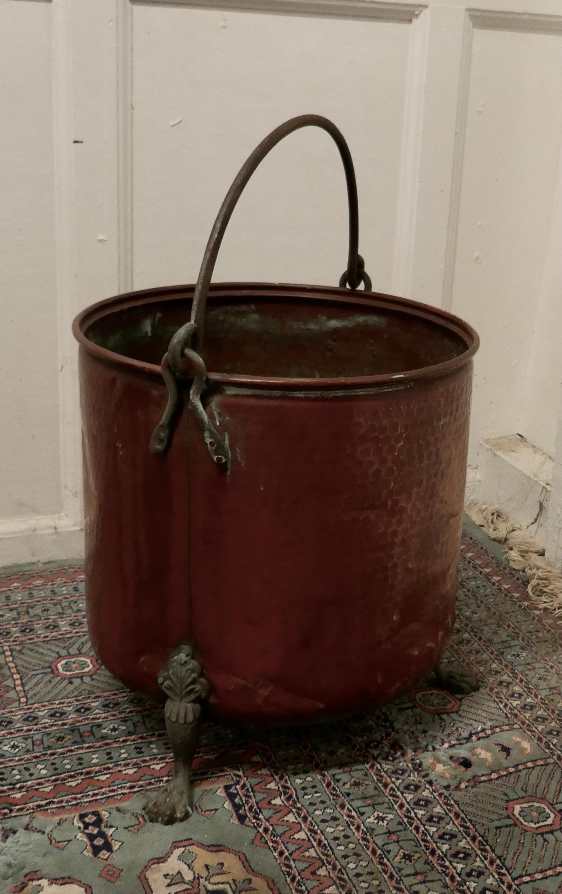19th century copper coal bucket on brass feet

This is a lovely big beaten copper coal bucket, this is a good big piece and would make a really good coal or log container and handy because it has a riveted iron carrying handle and it stands on