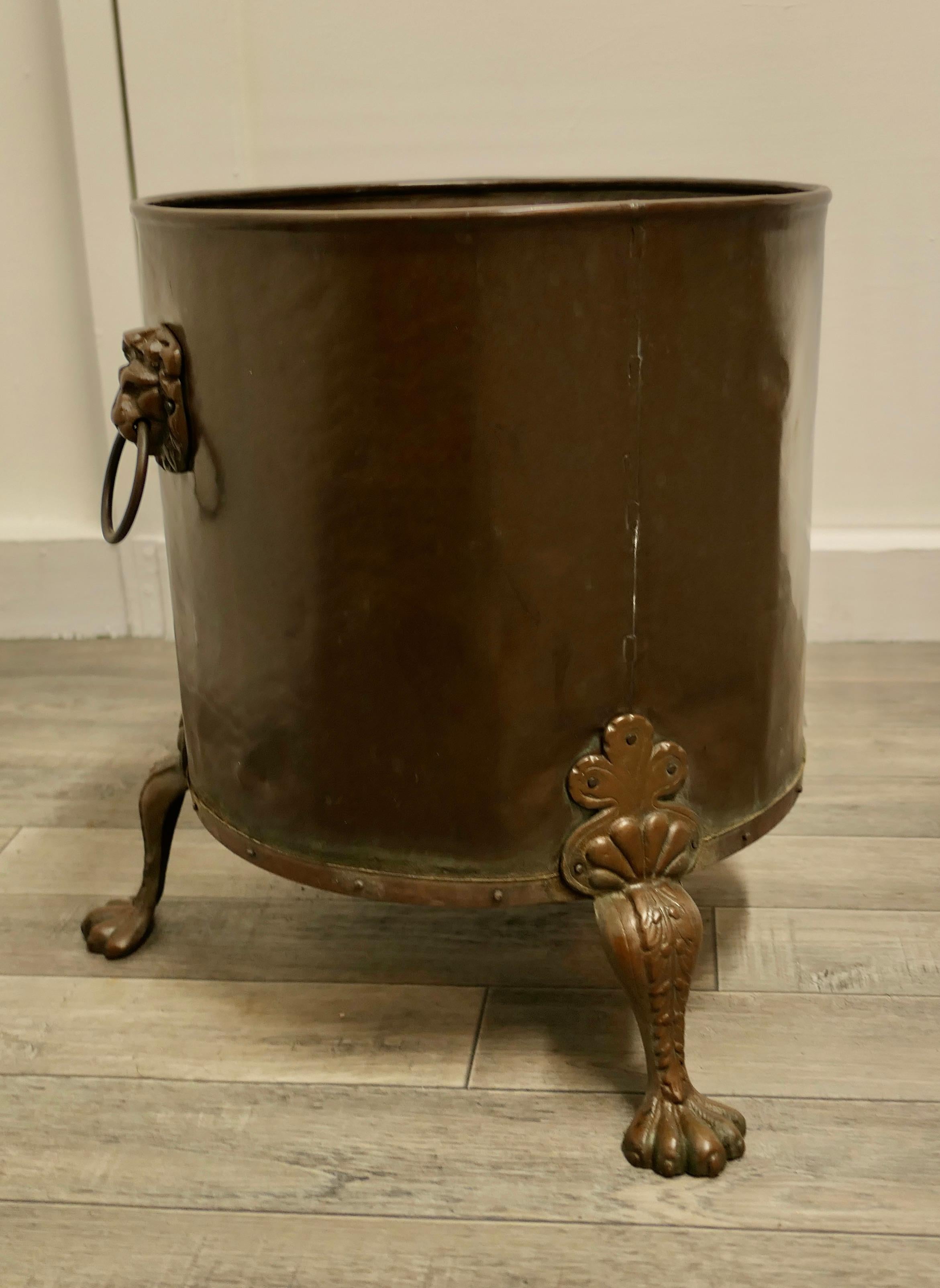 19th century copper coal or log bucket on lions paw feet

This is a lovely looking 19th Century bucket it has a riveted base with lions paw feet and Lions mask ring handles 
The bucket has a rolled top edge and it is in very good sound condition