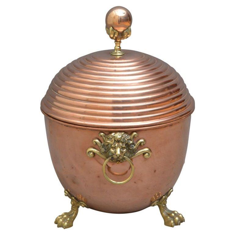 Unusual Regency revival coal bucket, having reeded lid with claw and ball finial, lion mask carrying handles and 3 paw feet. This coal bin would make a good planter. Cleaned, polished and ready to place at home. 1890
Measures: Height 18