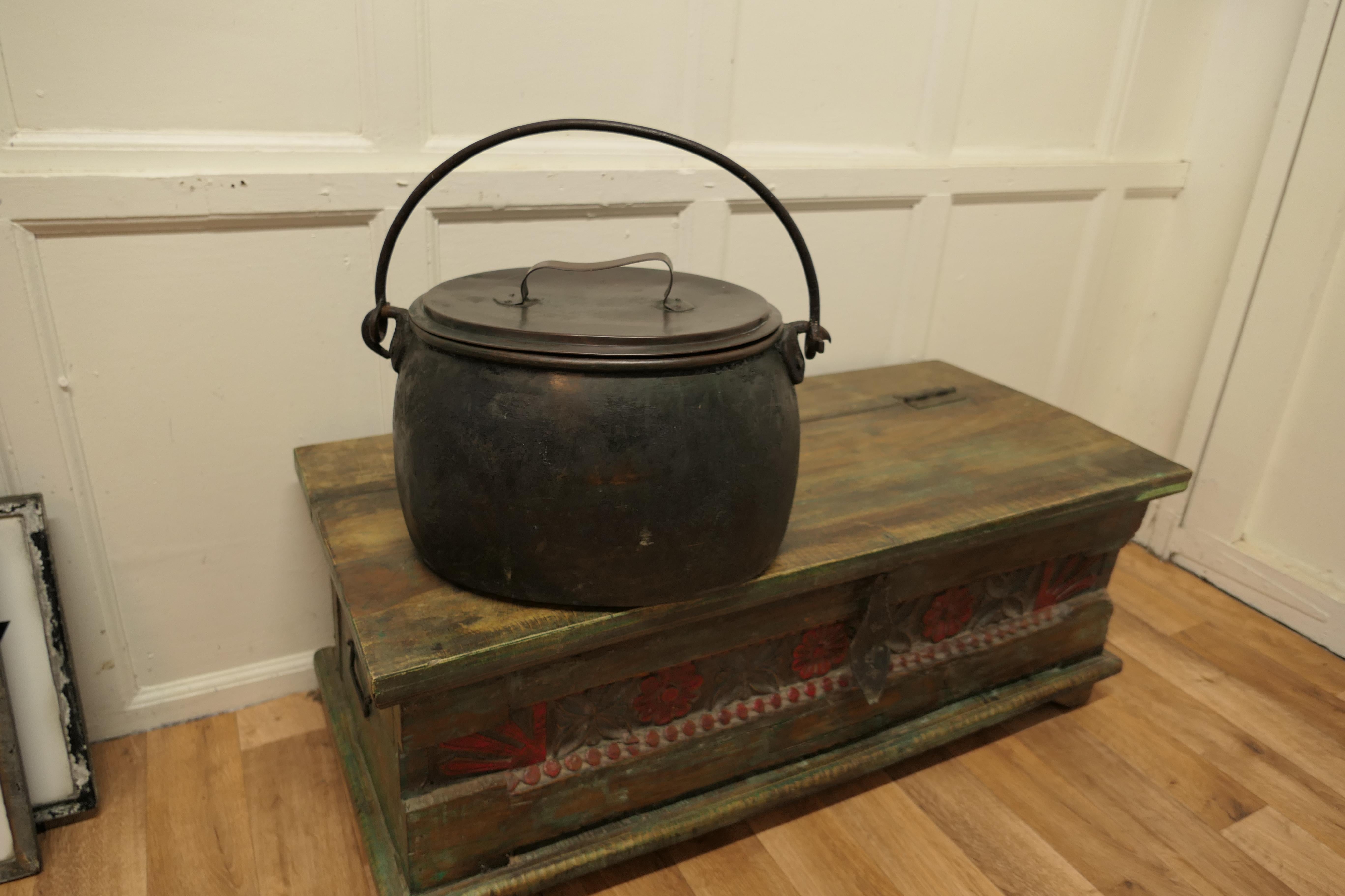19th Century copper cooking pot cauldron with lid.

This is a lovely looking and very rare find, a 19th Century cooking pot, this piece is totally original just as though it came straight from the fire.
The lid fits tightly and there are no