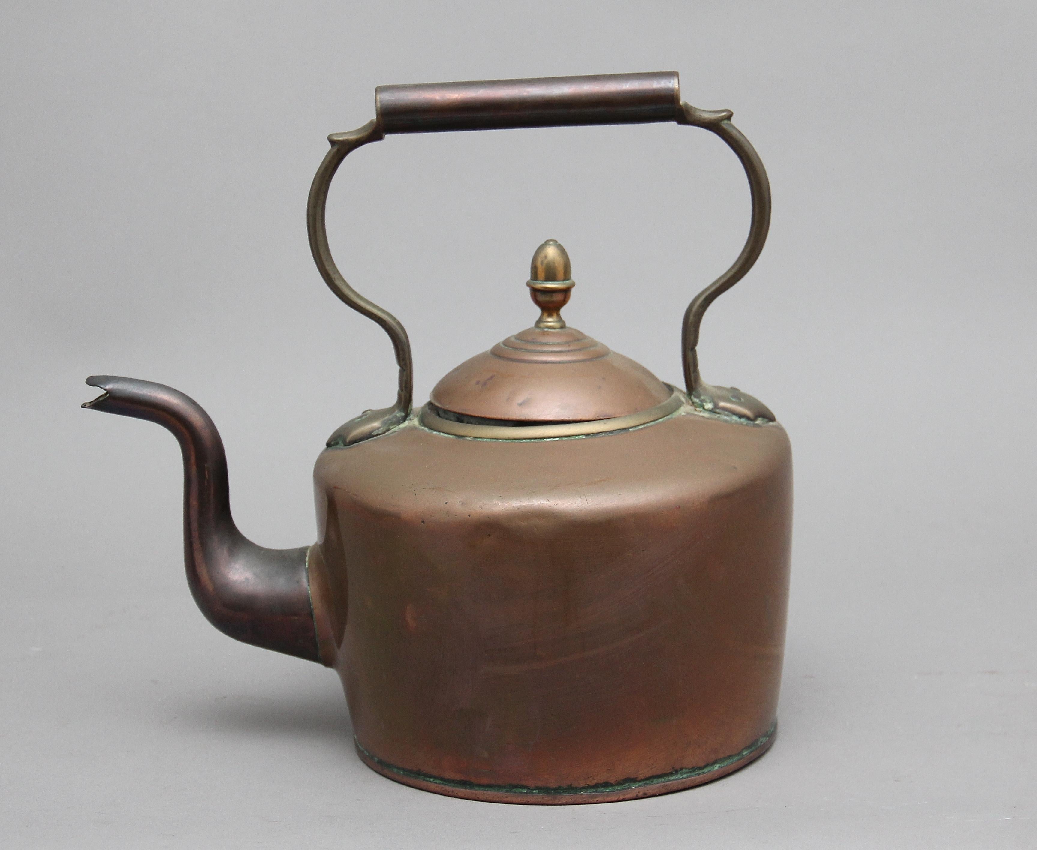 19th century brass copper kettle, having a shaped handle, acorn finial on the lid and a shaped spout, circa 1860.
  