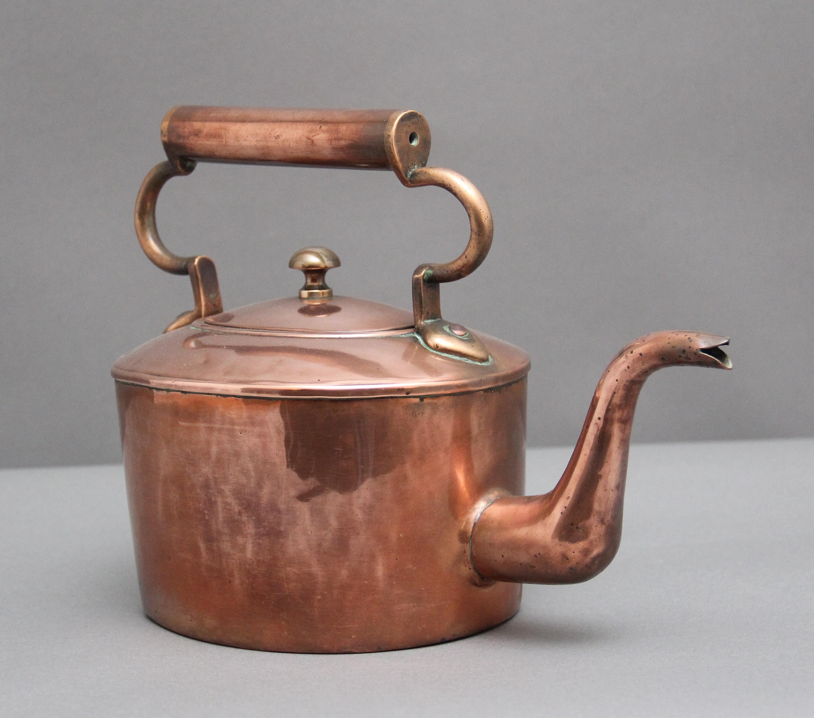 19th Century copper kettle, having a shaped handle, turned finial on the lid and a shaped spout.  Circa 1860.
