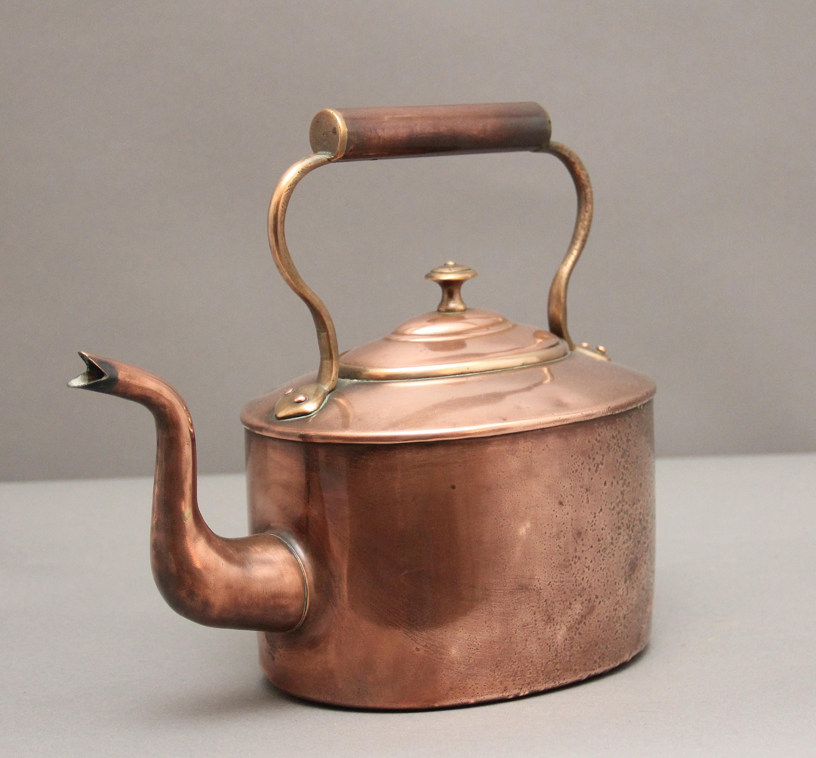19th Century copper kettle, having a shaped handle, turned finial on the lid and a shaped spout.  Circa 1860.