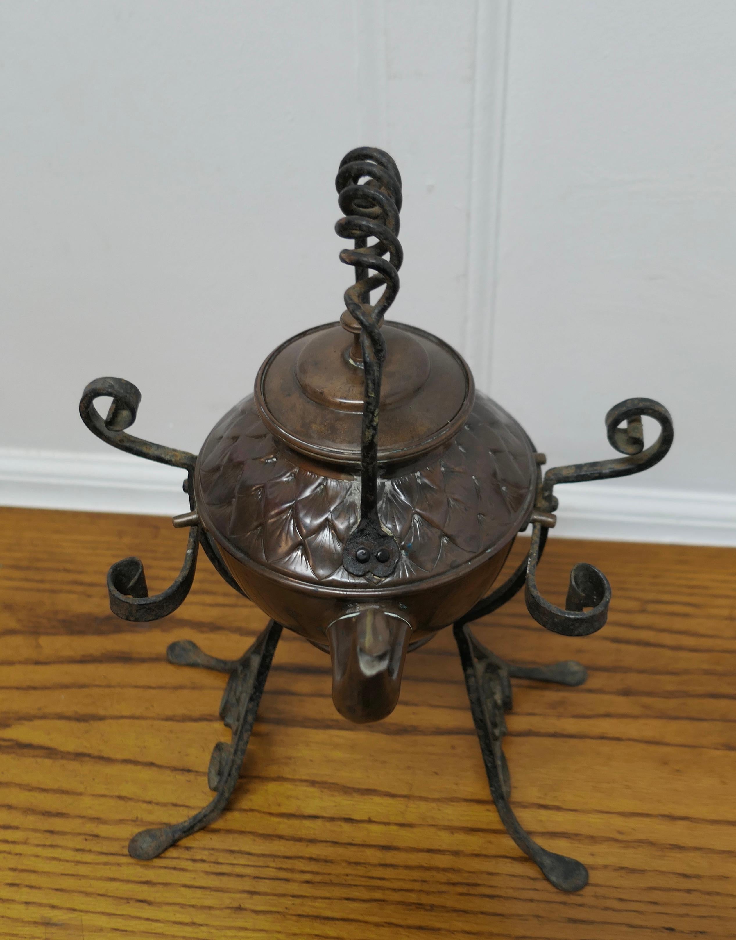 19th Century Copper Kettle on a Wrought Iron Stand  

This charming Arts and Crafts Kettle stands on its own wrought iron stand
The kettle is 15” high on the stand, 11” wide and 10” deep
TVY151
