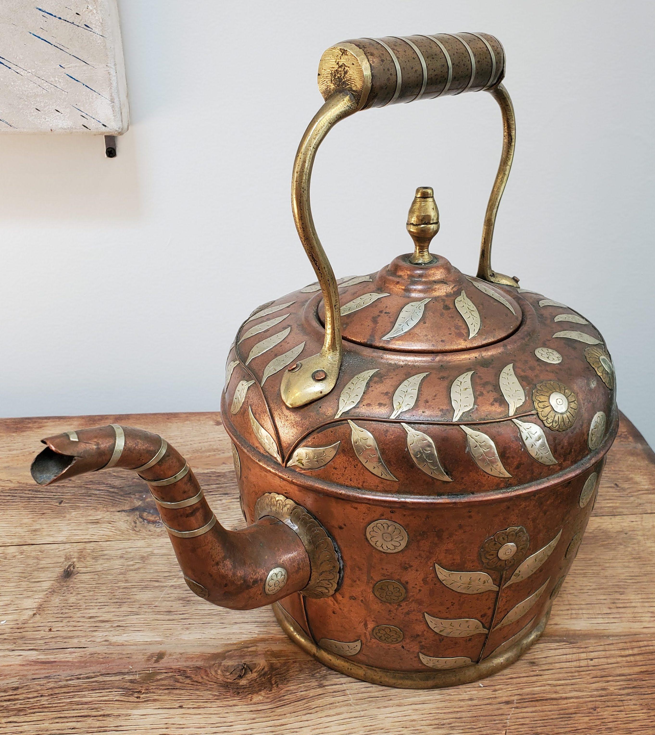 This beautiful 19th century copper kettle is perfect for any teapot collector. Made in India during the British Empire in a typical English form with copper with brass and silver floral decoration. Made circa 1850.
Measures: 12.5” H, 8” Dm.