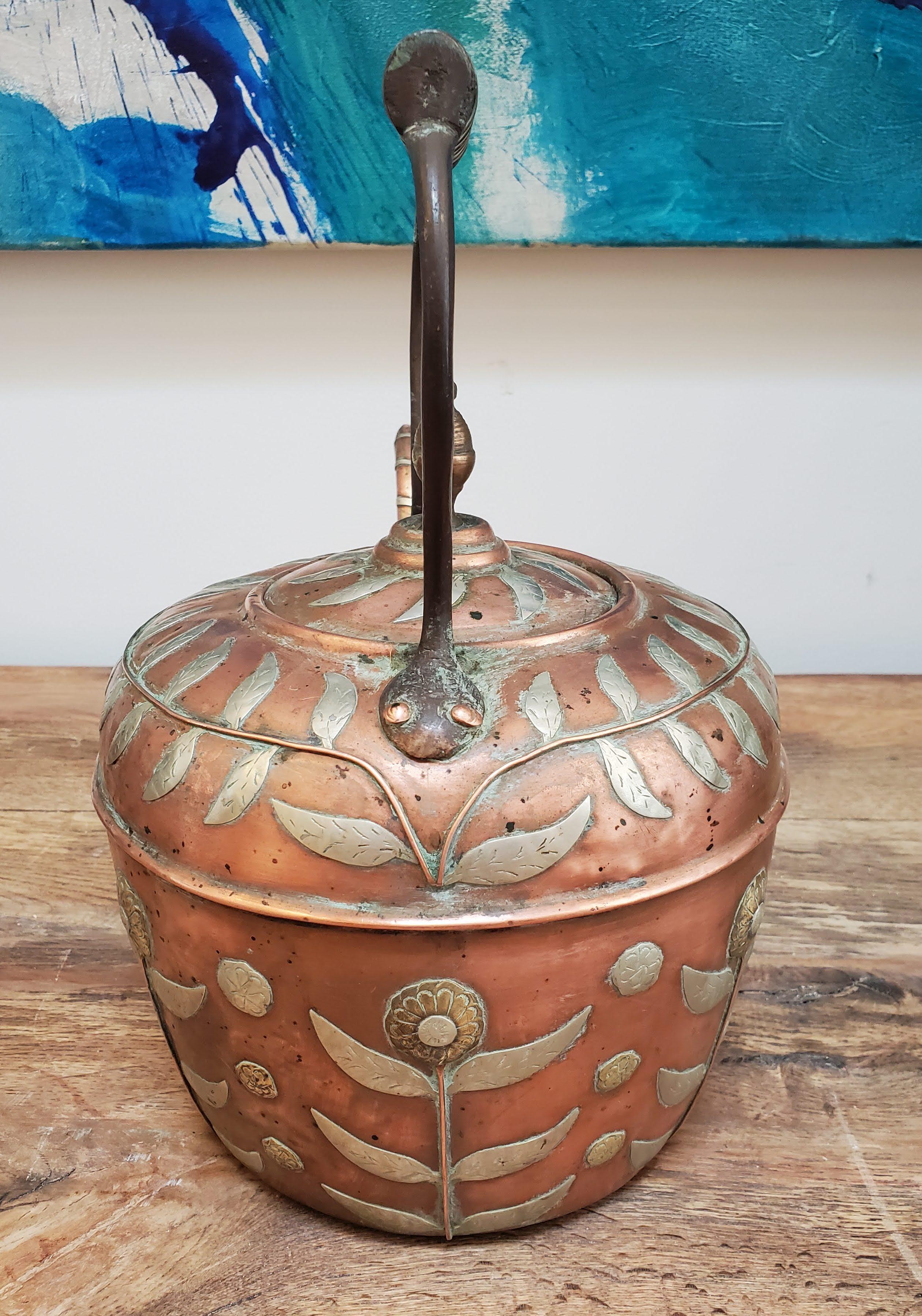 This beautiful 19th century copper kettle is perfect for any teapot collector. Made in India during the British Empire in a typical English form with copper with brass and silver floral decoration. Made circa 1850.
Measures: 12” H, 7.5” Dm.