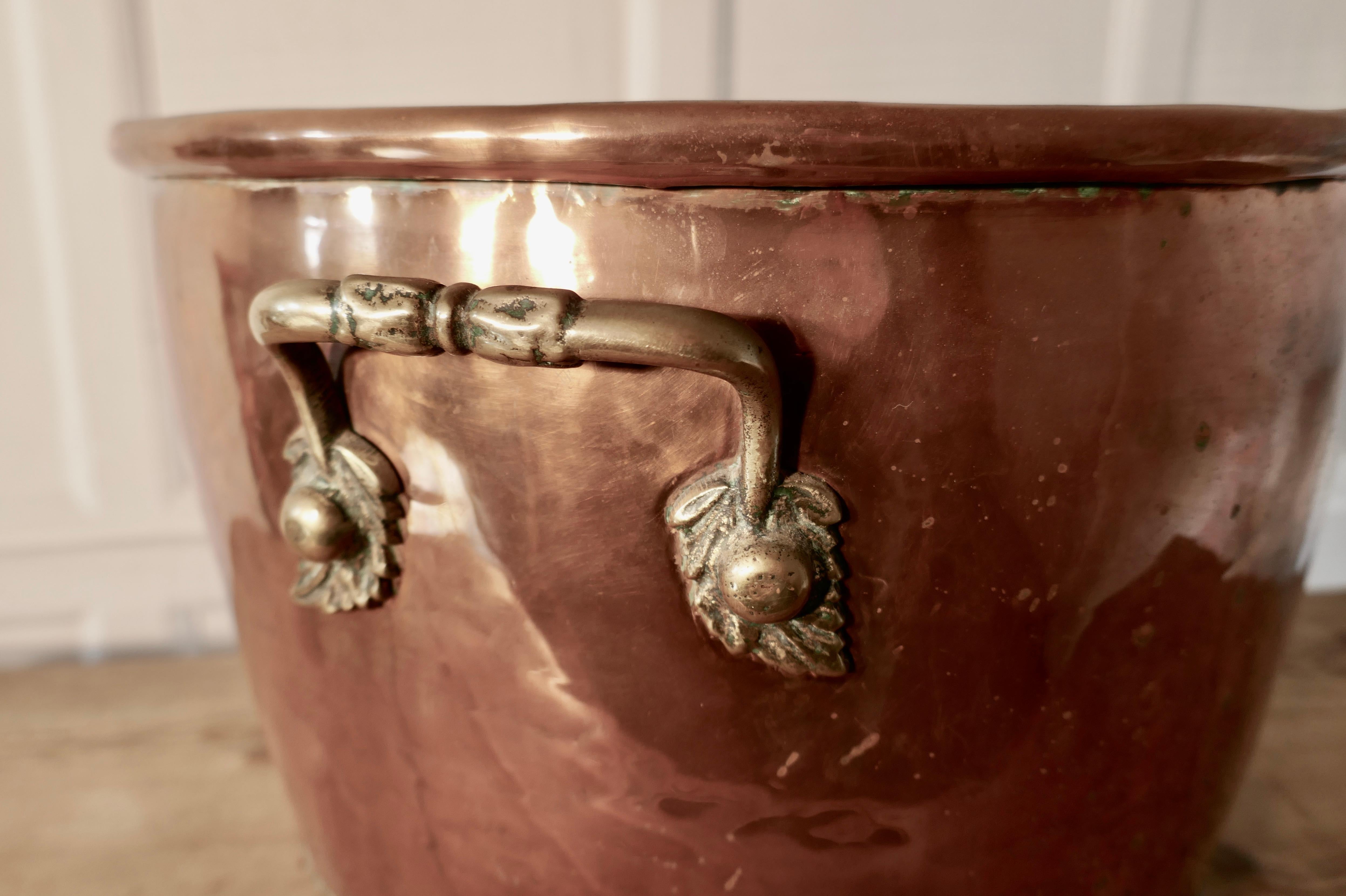 19th century copper log bin cauldron

This is a superior quality copper, it has a heavily riveted construction, it has riveted handles, also three chunky lions paw feet.

The copper cauldron would work well as a log basket or as planter for a
