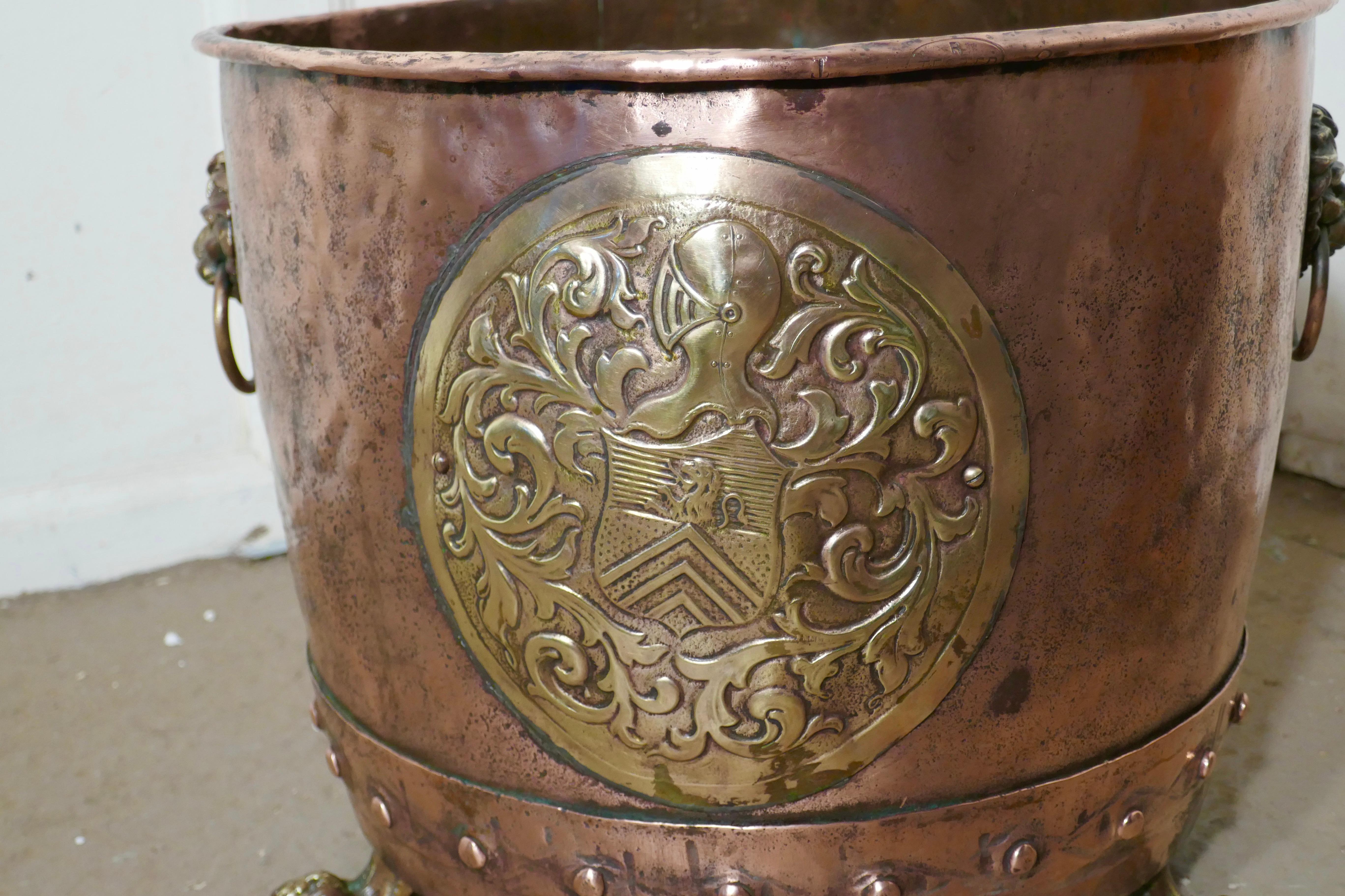 19th century copper log bin or planter

This is a superior quality copper, it has a riveted construction, and is no longer required to heat water in it has a brass heraldic crest on the front lions mask ring handle and three strong lions paw