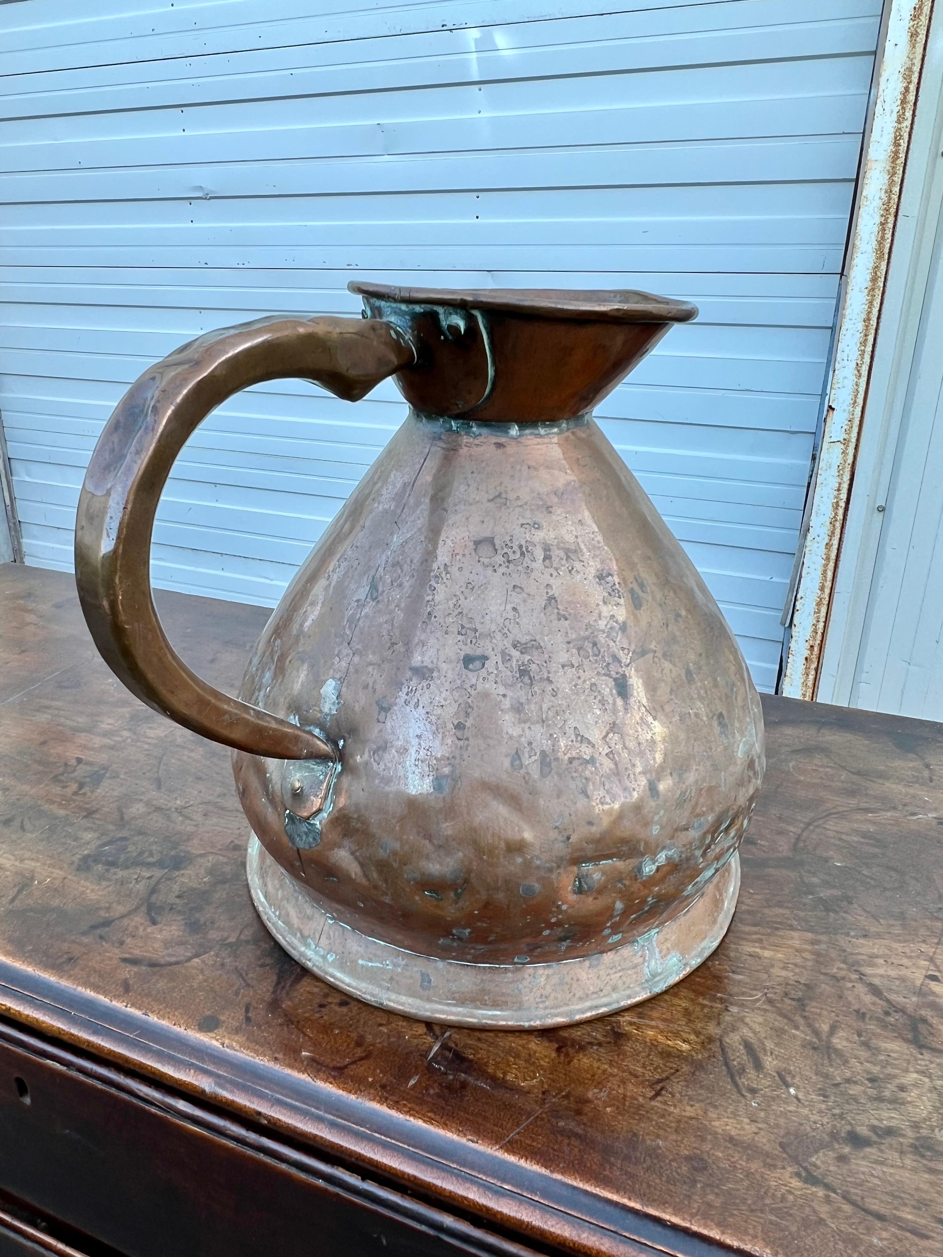 19th century copper pitcher/measure.  Nicely sized vessel with pleasing silhouette.  Stamped on the front 