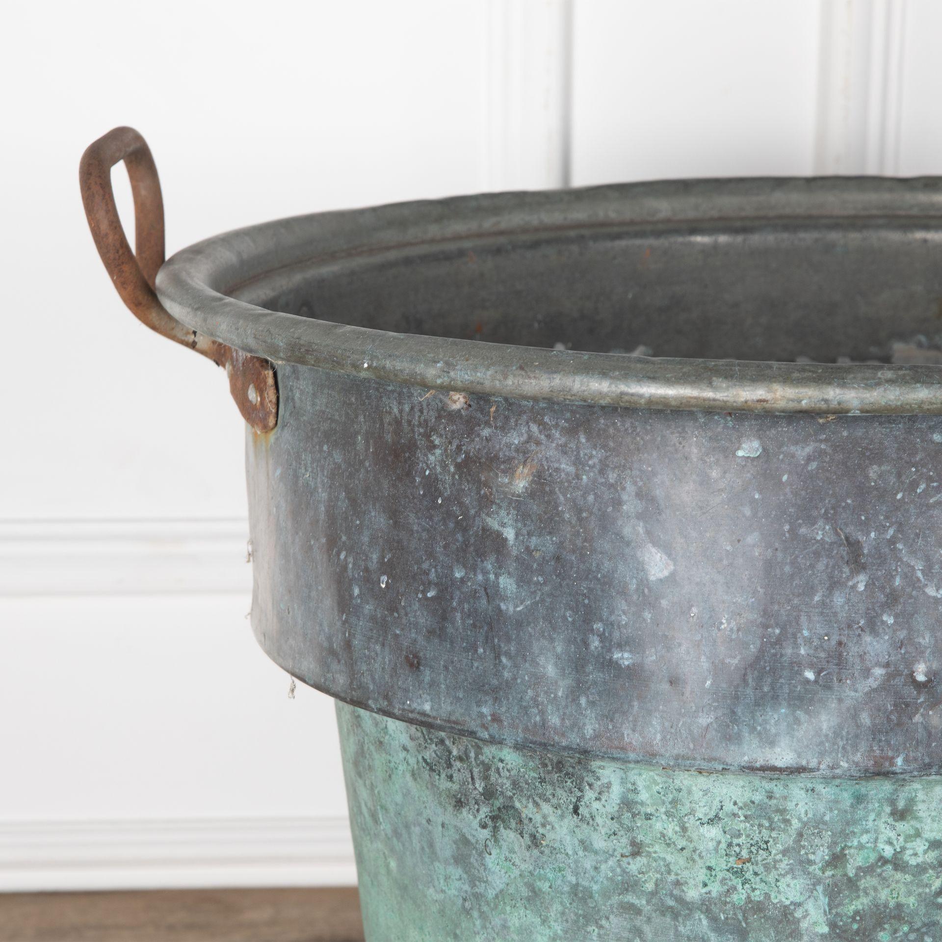 19th Century patinated copper vessel with iron handles.