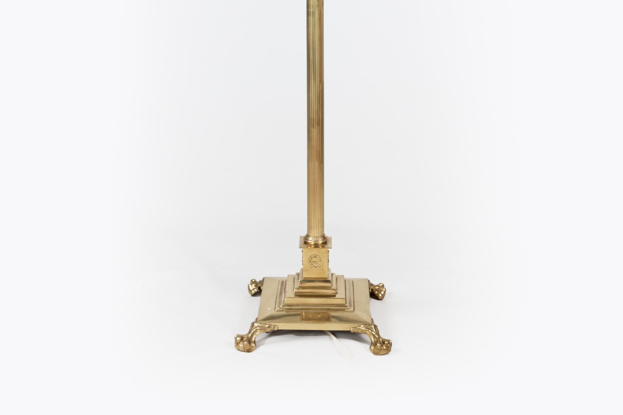 19th century brass adjustable standard lamp of Corinthian column-form raised on a stepped square base and four lion paw feet - converted to electricity.

Height adjustable, 4ft at lowest and 6ft at tallest.