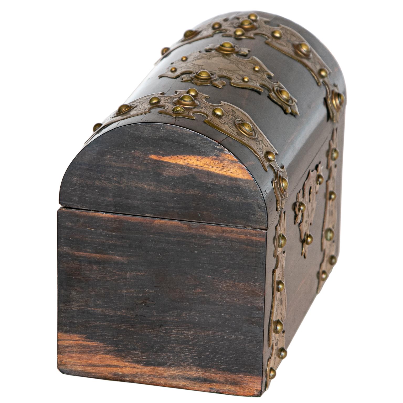 A middle of the 19th-century Victorian coromandel wood veneered dome top tea caddy. The caddy has gilded brass mounts.
 