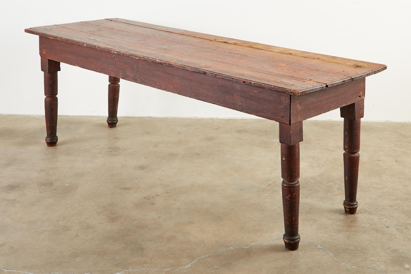 Rustic early 19th century country American farmhouse work table. Features a 1 inch thick pine plank top. Constructed with hand-made nails and later machine made nails having some older repairs. Each side of the table measures 25.5 inches from the