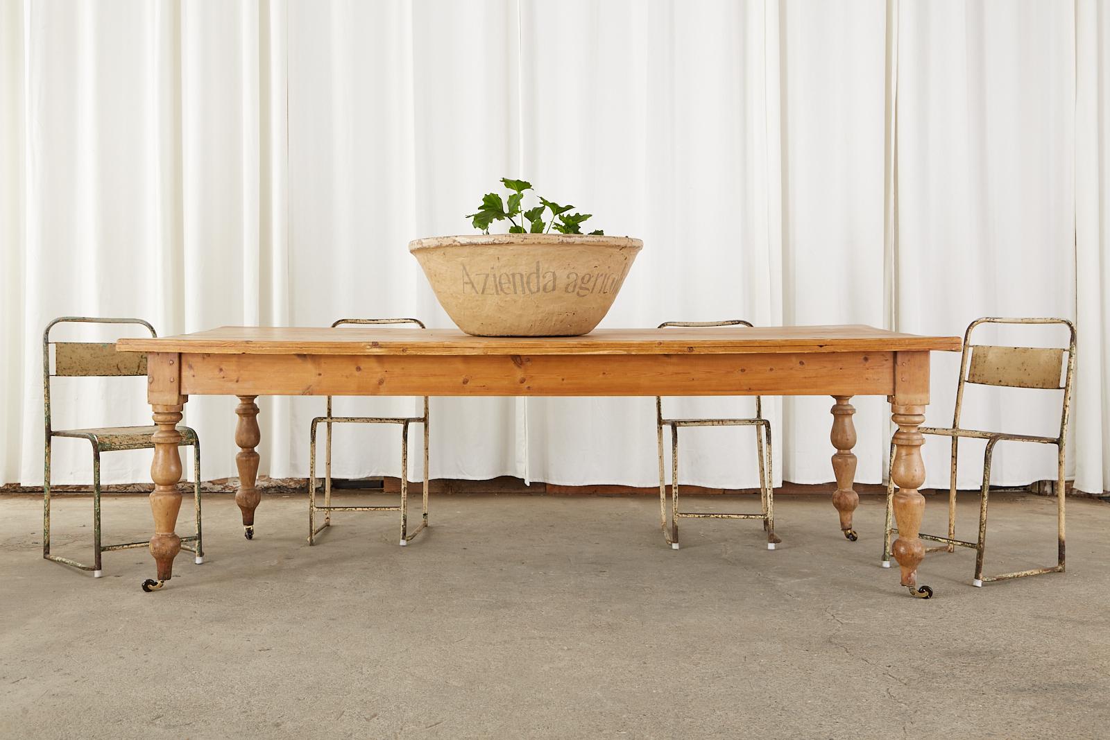 Rustic late 19th century country English farmhouse dining table or harvest table crafted from pine. This grand table features an 8 foot long rectangular plank top with a thick 1.5 inch border on the edges. The top is supported by large, chunky