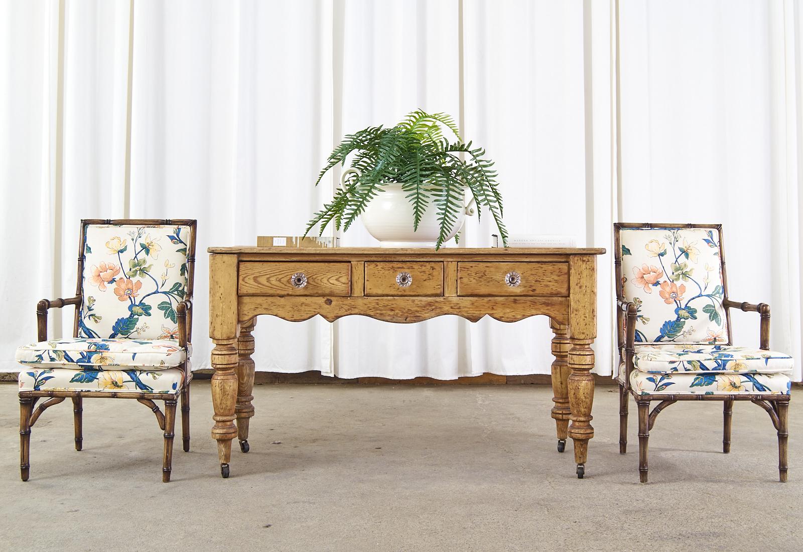 Rustic 19th century country French Provincial console table or server crafted from pine. The table has a plank top and is fronted by three storage drawers having shaped glass knobs. The console features a beautifully aged, distressed patina on the
