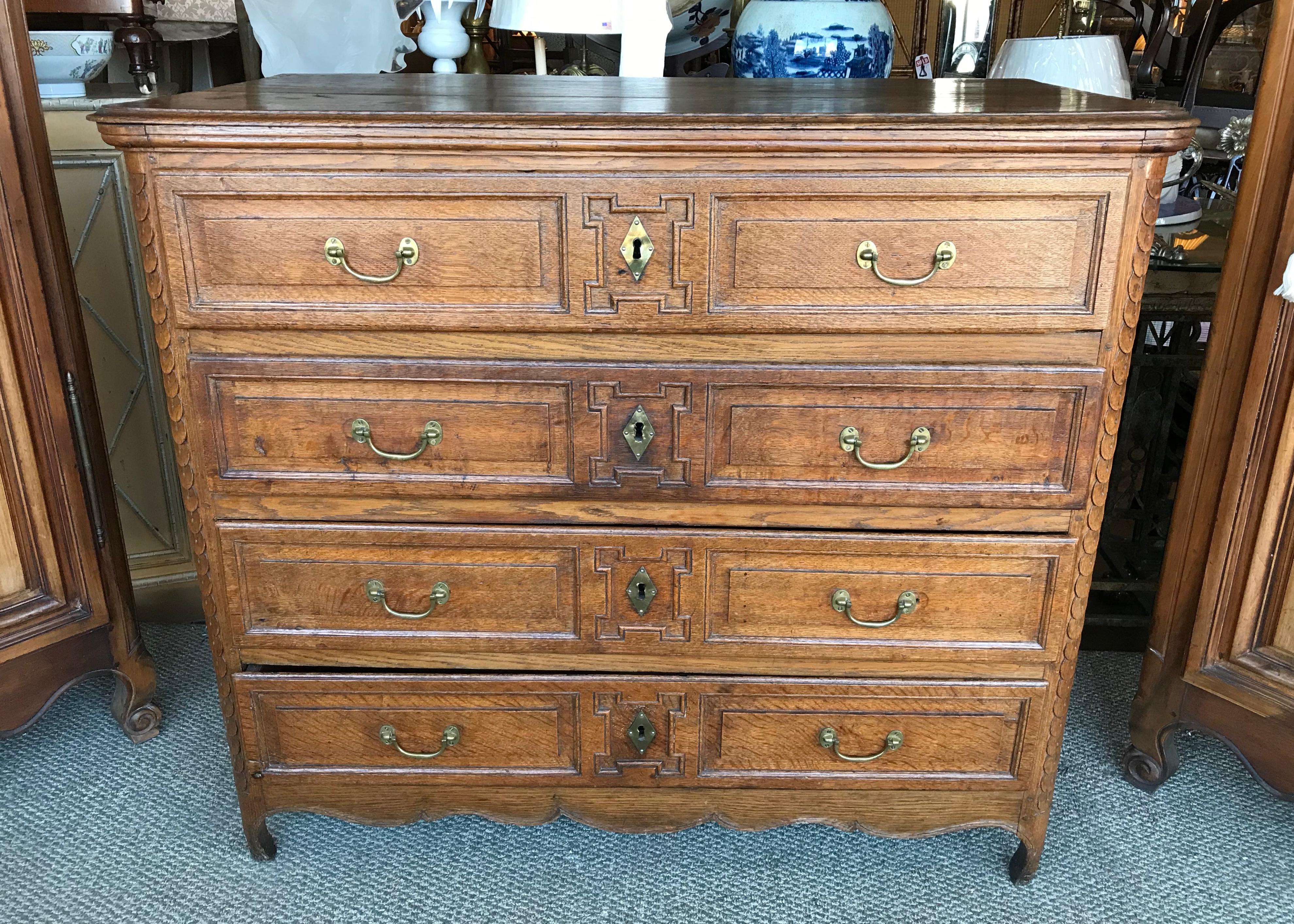 A beautiful Provincial piece with deep and richly carved design.
Fashioned in oak with a beautiful patina and fitted with 4 drawers.
Outstanding hardware.