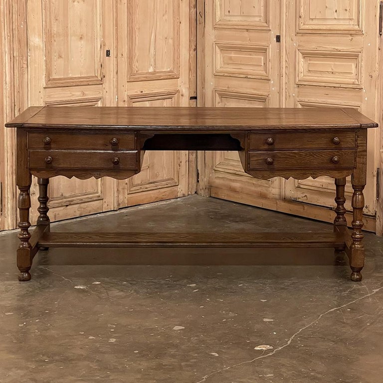 19th century Country French desk was hand-crafted from solid oak to last for generations! Solid plank top overlooks four drawers and a generous knee hole that uncharacteristically provides 28