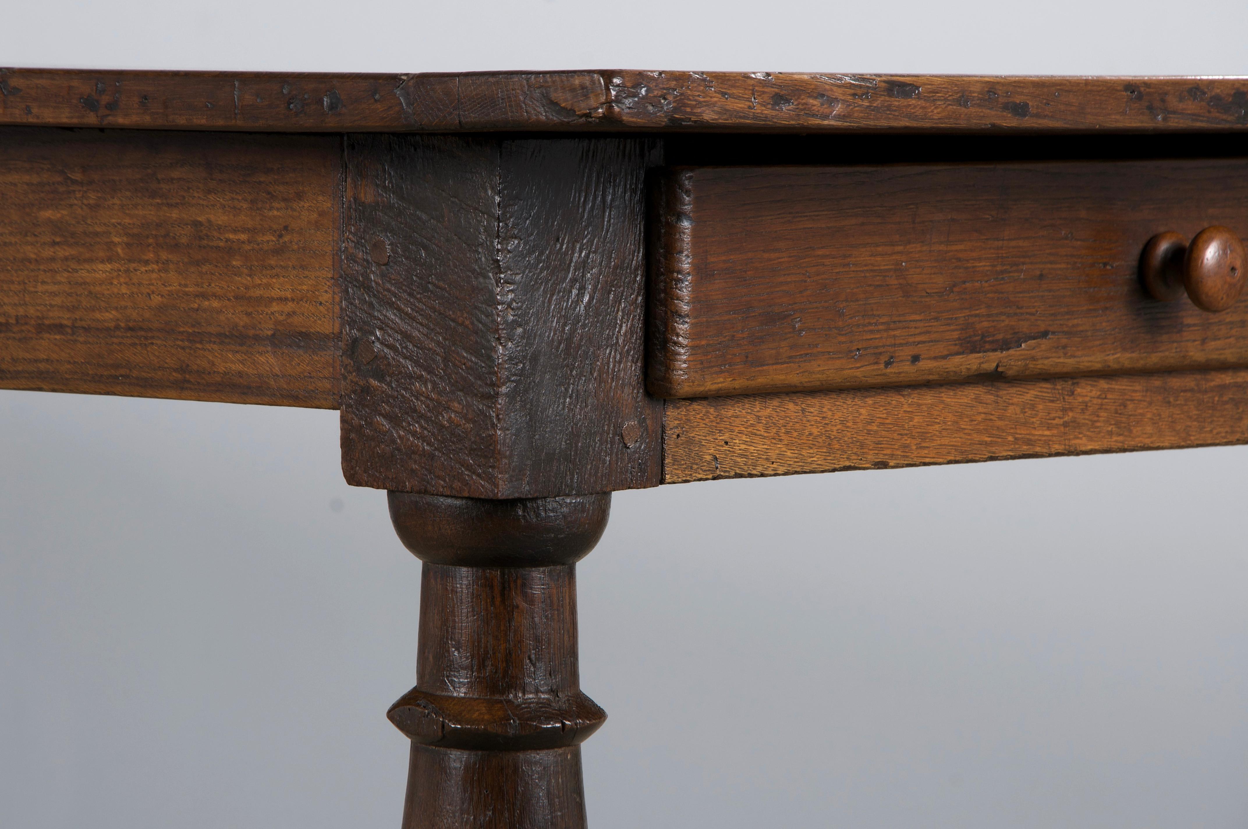 A handsome mid-19th-century French Provincial farmhouse dining or kitchen table, sourced directly from Provence, France. Beautifully handcrafted from solid oak, it features an 8-foot-long rectangular plank top with breadboard ends and exposed wooden