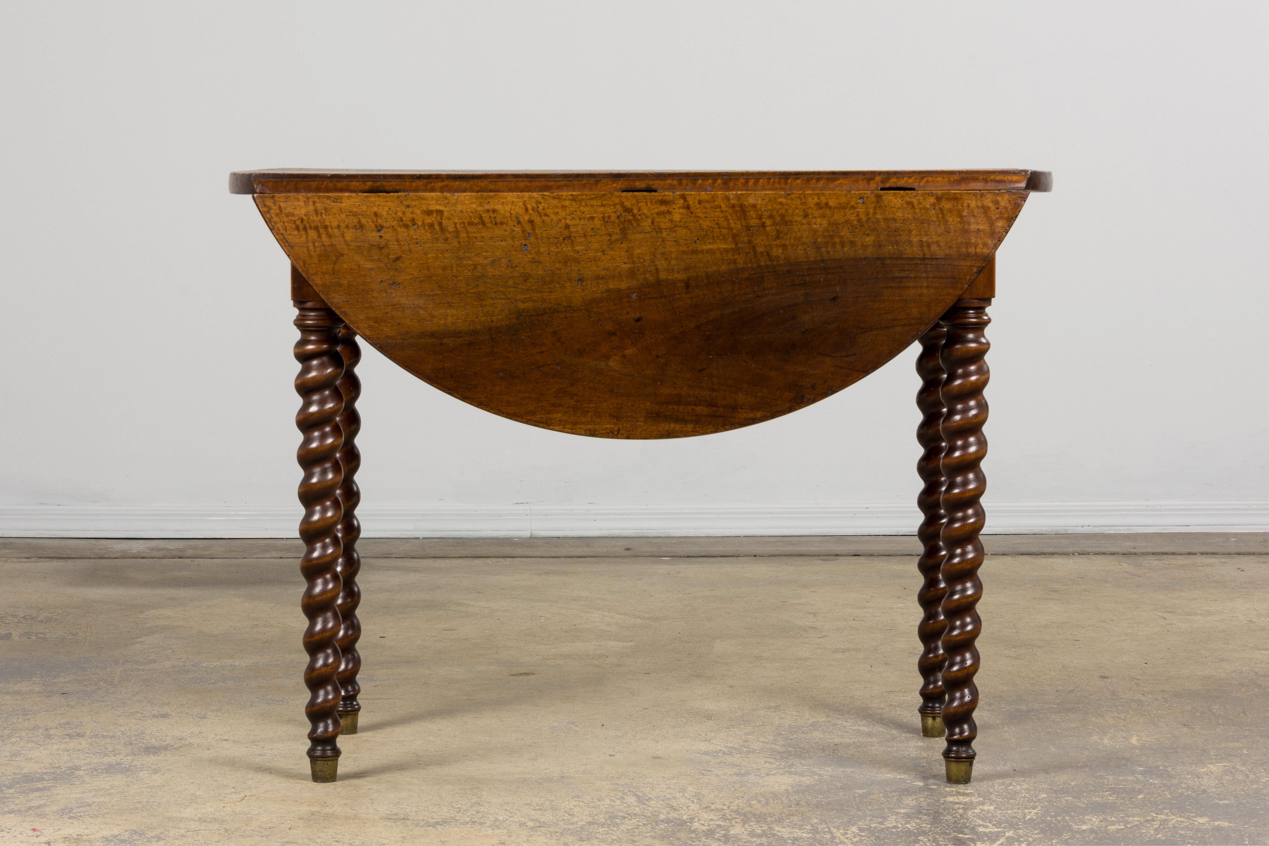 An elegant mid-19th-century country French drop leaf table made in Louis XIII style, sourced from Provence, France. Beautifully hand-carved from solid walnut wood, it features a narrow rectangular profile perfect for a console or side table. The