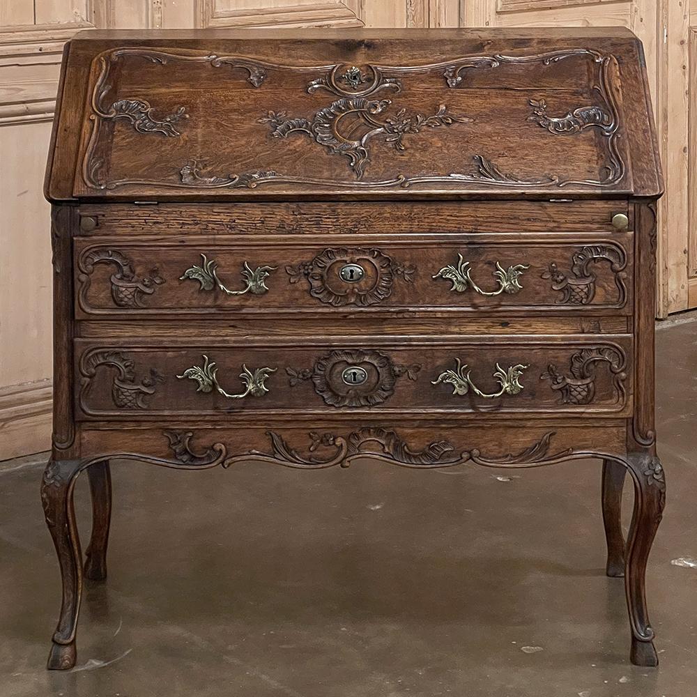 19th Century Country French Louis XV secretary is a classic slant-front design, originally conceived as a compact writing desk that could be placed against the wall with a minimal footprint, but still provide a spacious work surface and storage