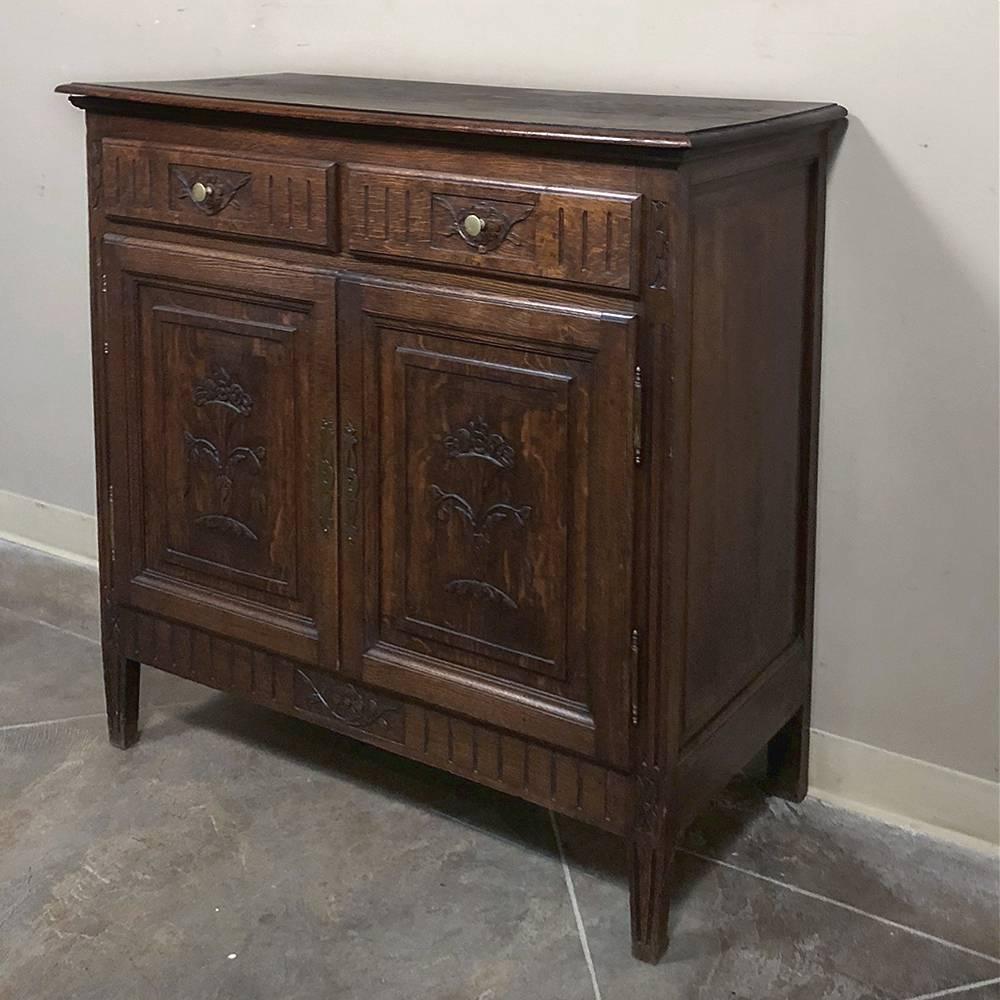 19th century Country French oak petit buffet features Louis XVI style and tailored lines that is reminiscent of the neoclassic designs dating back to three thousand years, yet retains a local, rustic charm that is undeniably provincial! Floral and