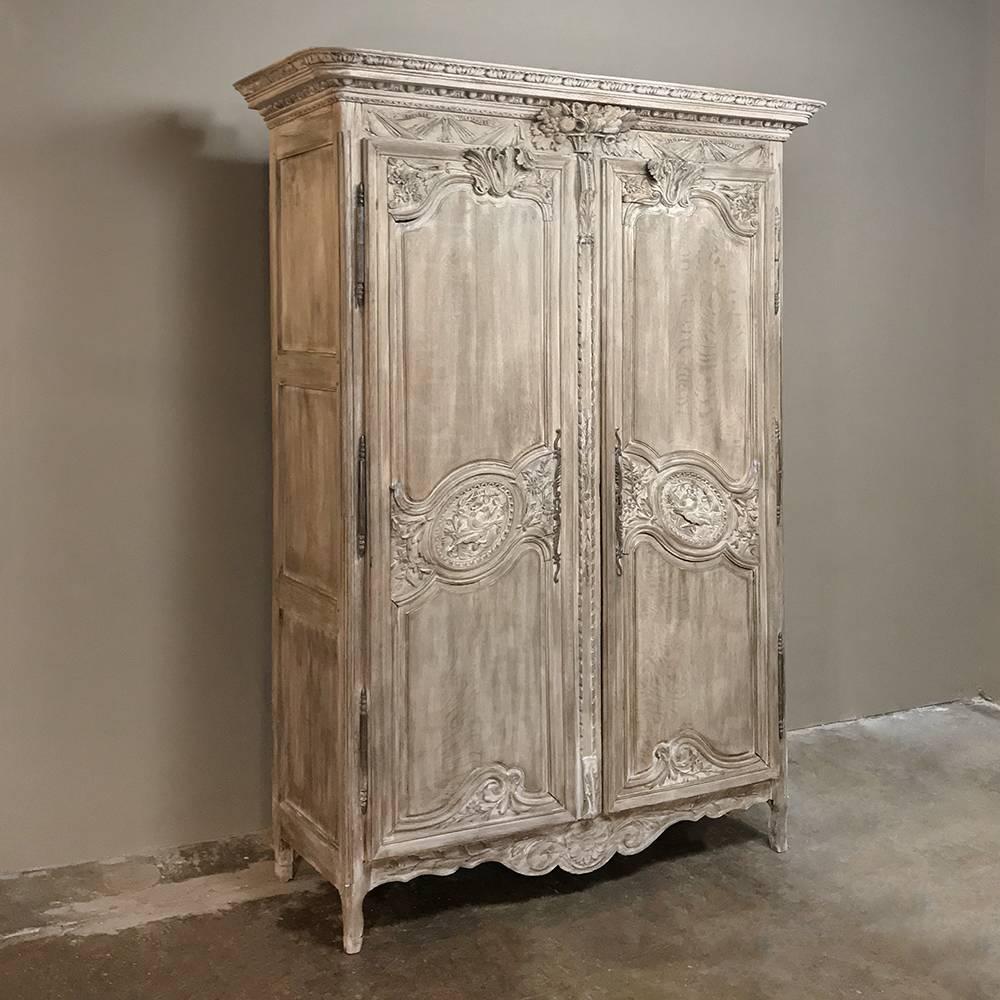 19th century Country French Normandy stripped oak wedding armoire is a wonderful example of the breed, handcrafted and sculpted from indigenous old-growth oak to last for generations! Classic scrolled door framework is adorned with lovebirds,