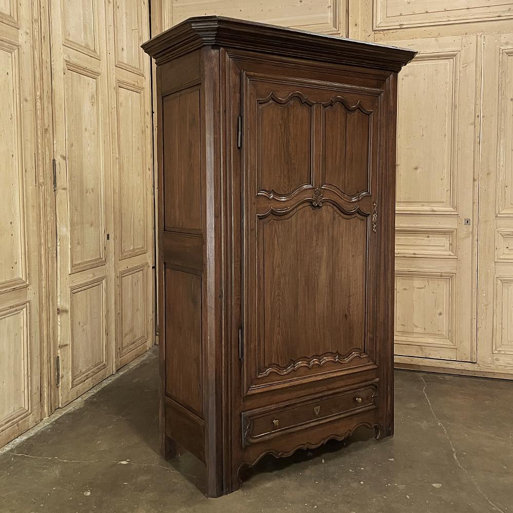 19th century Country French oak Bonnetiere ~ Armoire features tailored, neoclassical architecture rendered from heavy planks and timbers of old growth oak to ensure this keepsake will last for centuries! The boldly molded crown rests directly on the