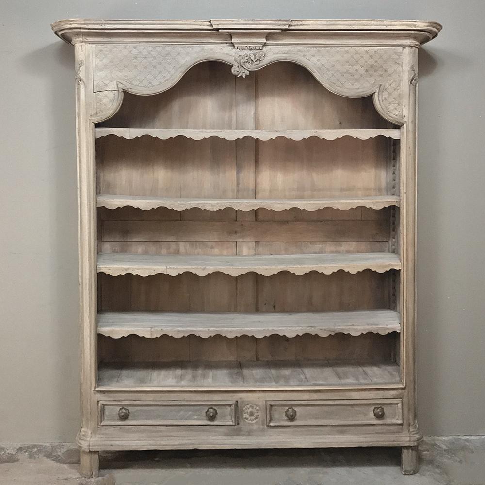 Early 19th century Country French open Baroque bookcase is nice and shallow, making it a good choice for home libraries and modern offices or lobbies. Carved embellishments include intricately scrolled upper apron below a bold crown molding,
