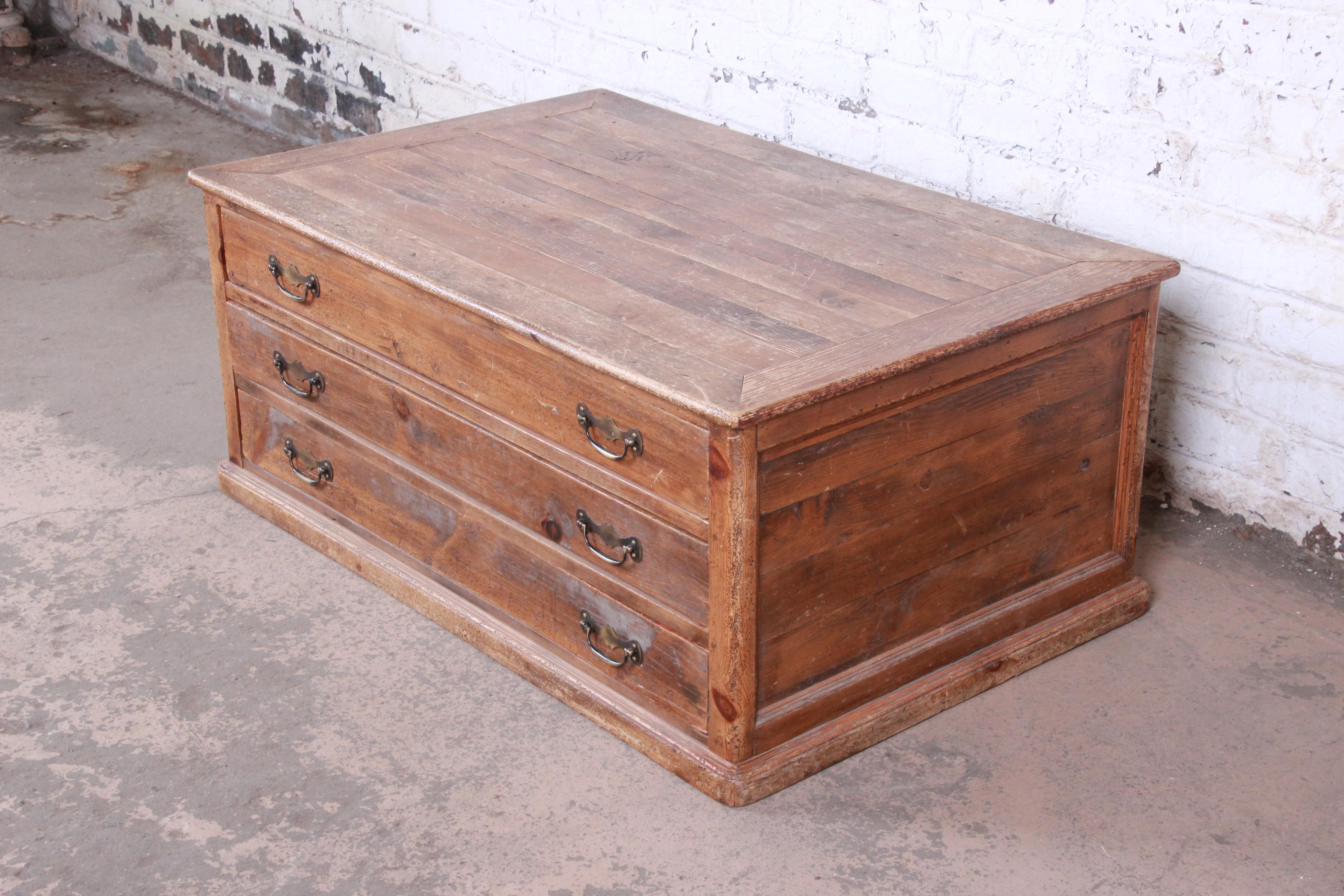 A rare and exceptional Country French primitive pine double-sided three-drawer map or flat file cabinet--perfect for a coffee table

France, late 19th century

Solid pine, with original brass hardware. Drawers pull out on each side.

Measures: