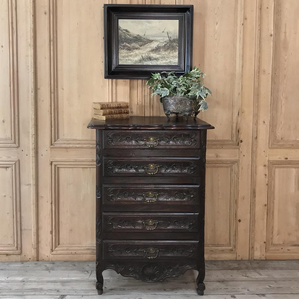 19th century country French provincial Chiffoniere was fashioned from solid oak, and features five drawers carved with charming detail and fitted with unusually intricate cast brass pulls,
circa 1890s
Measures: 39 H x 27.5 W x 17 D.