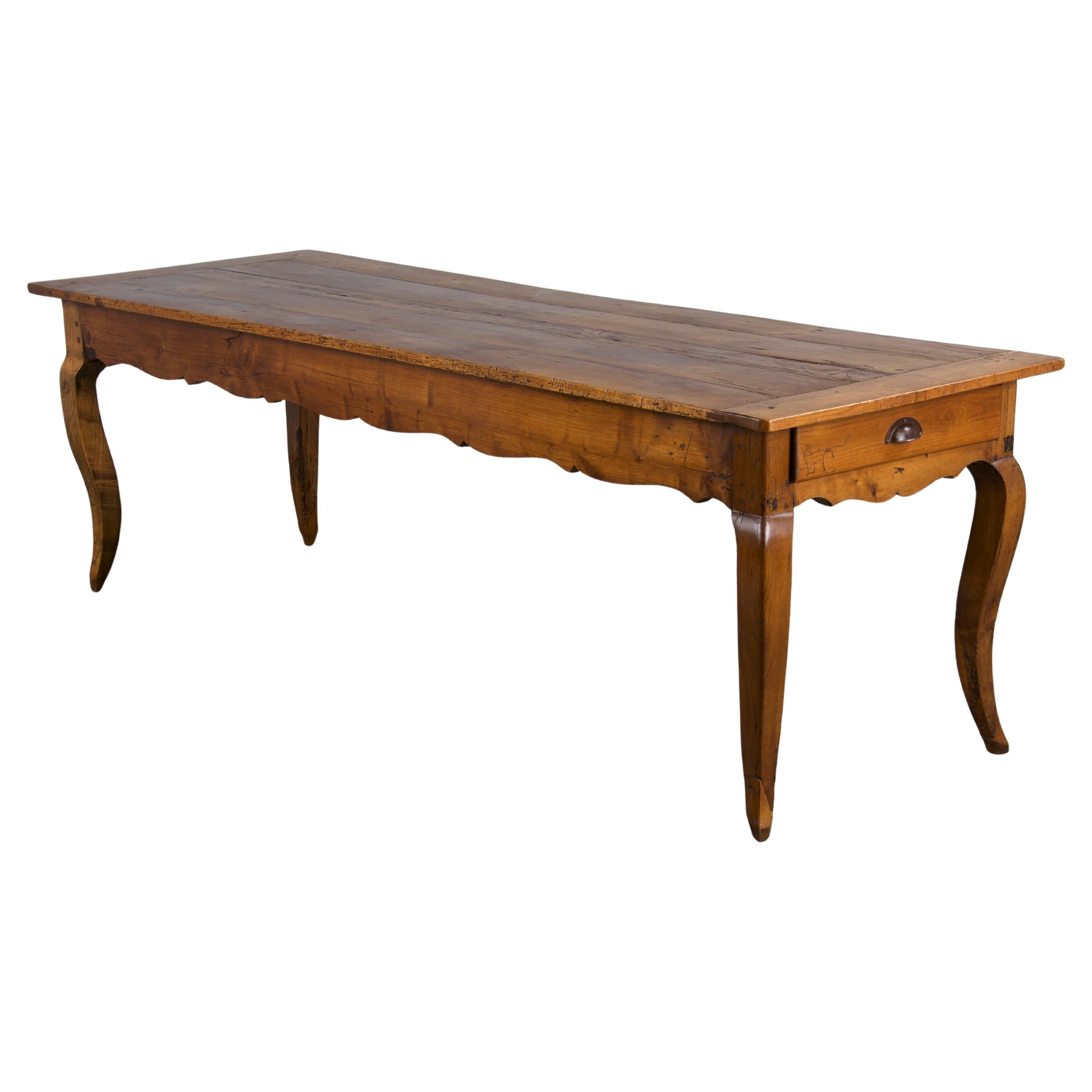 A mid-19th century French farmhouse dining table, sourced from Provence, France. Expertly hand-crafted from solid fruitwood, the table features a 7'6