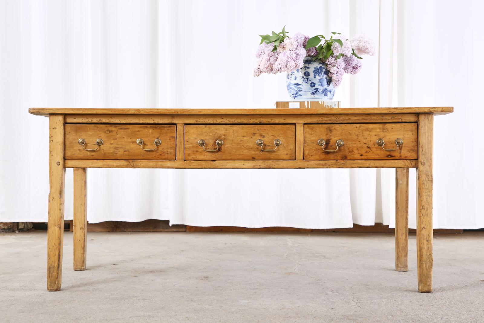 Beautifully aged 19th century country French provincial farmhouse console table or sideboard server. Constructed mostly from pine and fruitwood featuring a warm soft patina on the finish. The top has 1 inch thick plank boards and the case is crafted