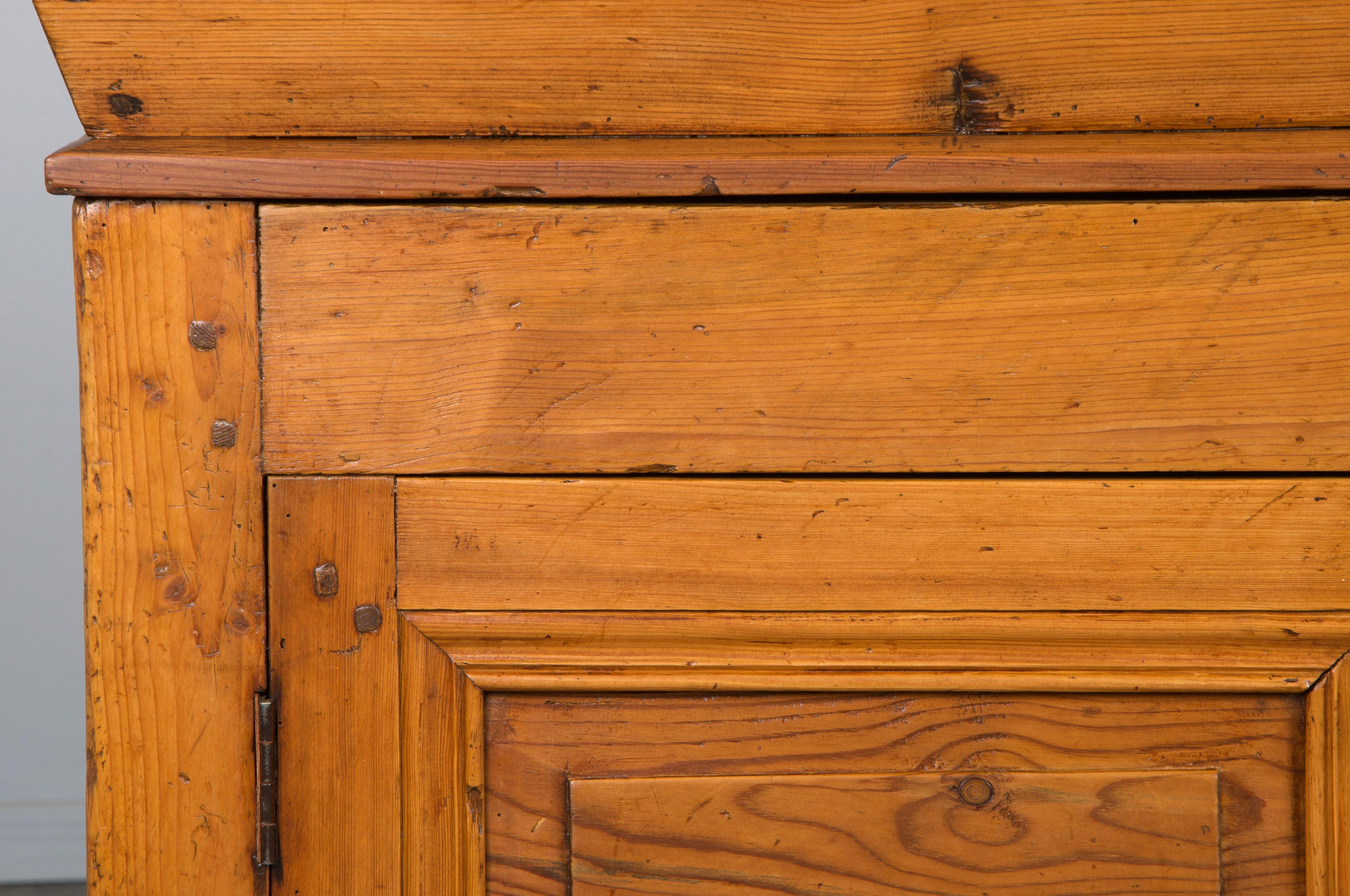 19th-century traditional French Provincial dough bin storage cabinet, sourced in Provence and entirely hand-crafted from solid rustic European pine. This piece features solid wood construction with a five-foot-long loose plank top that slides open
