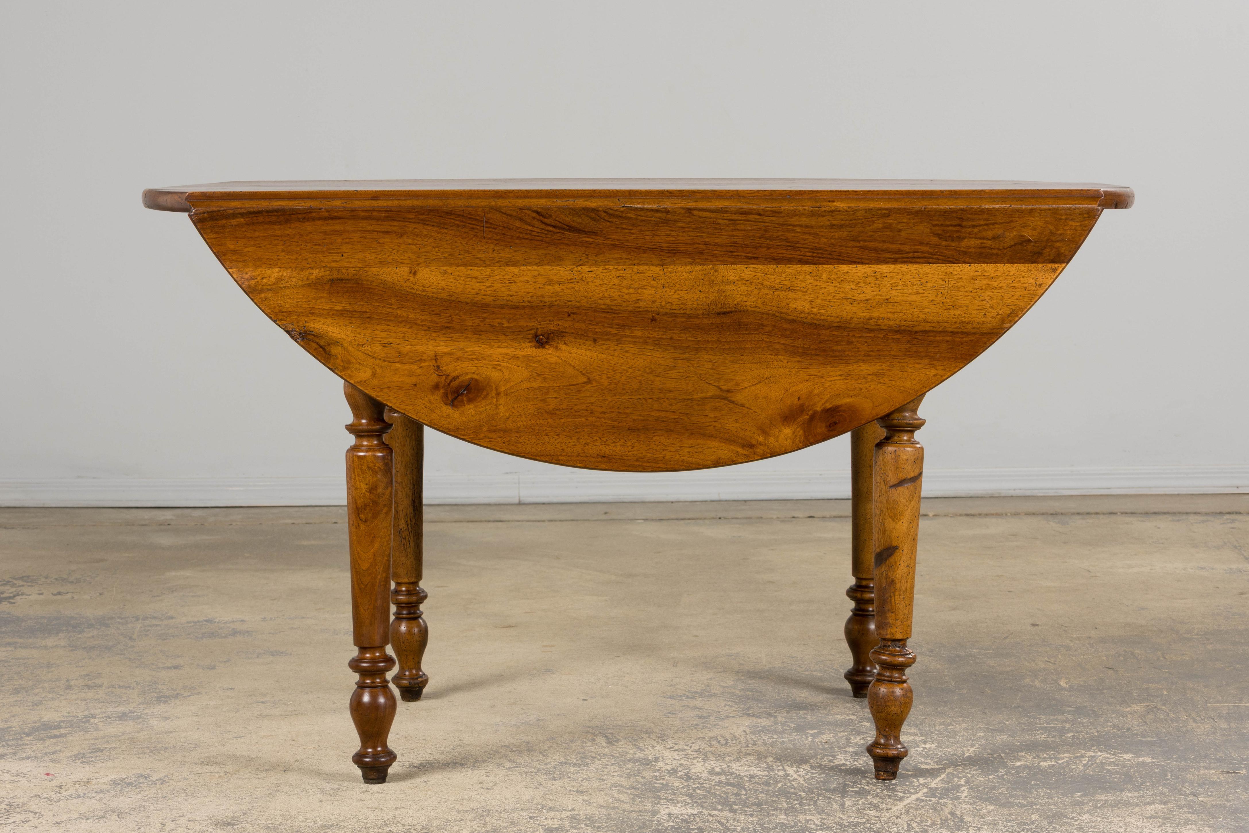 Hand-Carved 19th Century Country French Provincial Walnut Drop Leaf Table For Sale
