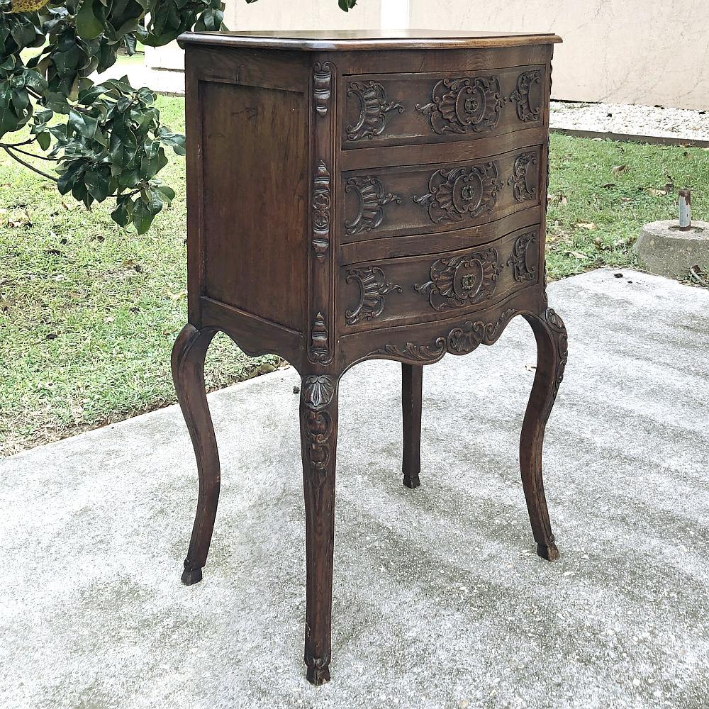 19th century country French Regence commode was meticulously handcrafted from dense, old-growth chestnut to create a splendid example of the cabinetmaker's art! Bowed front is lavished with stylized shell and foliate motifs in a symmetrical design,