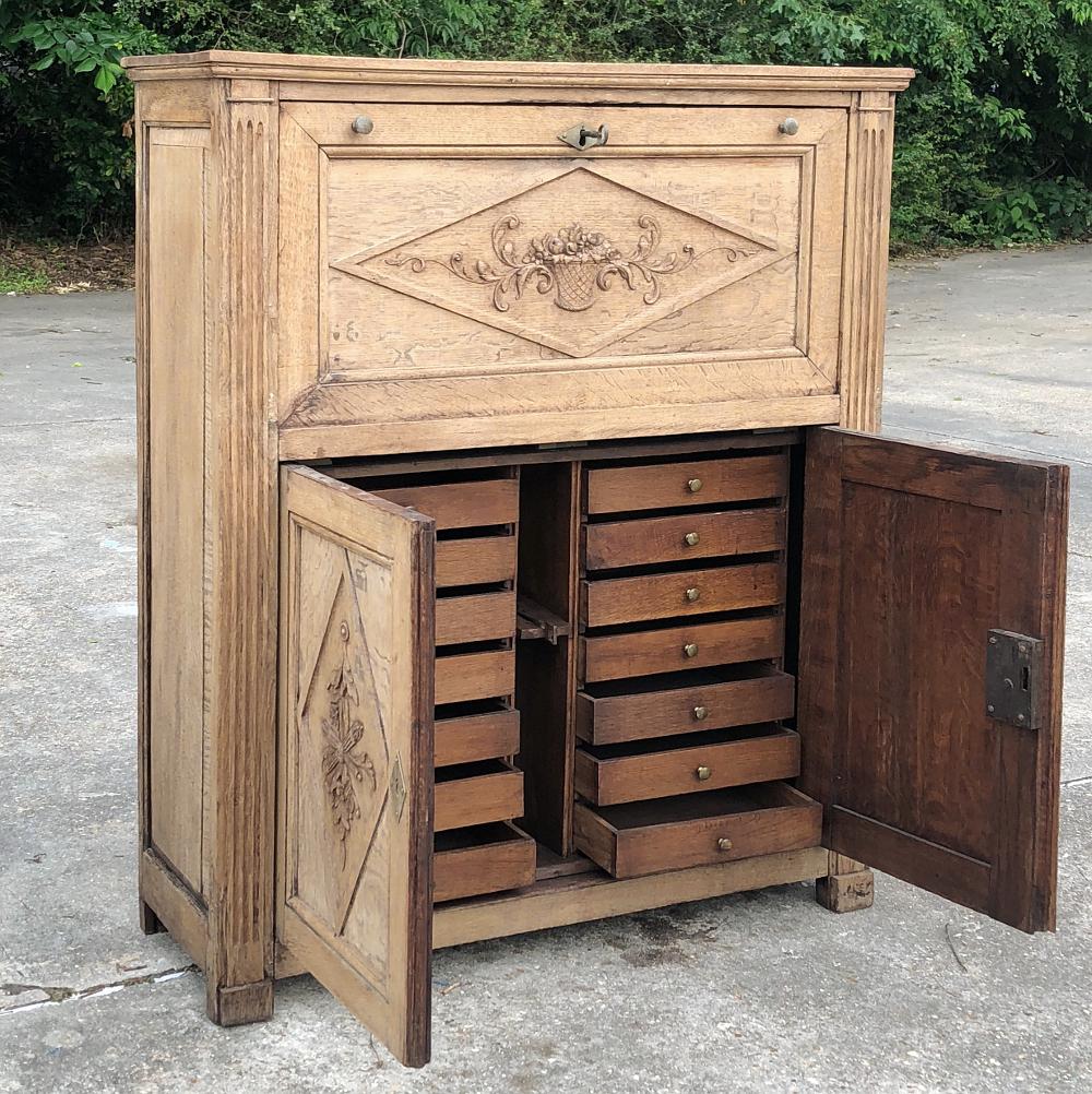 19th century country French rustic stripped secretary is great for the home office, a student desk, or even for use as a bar in the game room! Multiple drawers below combine with a large work surface and cabinet above, with subtle neoclassical