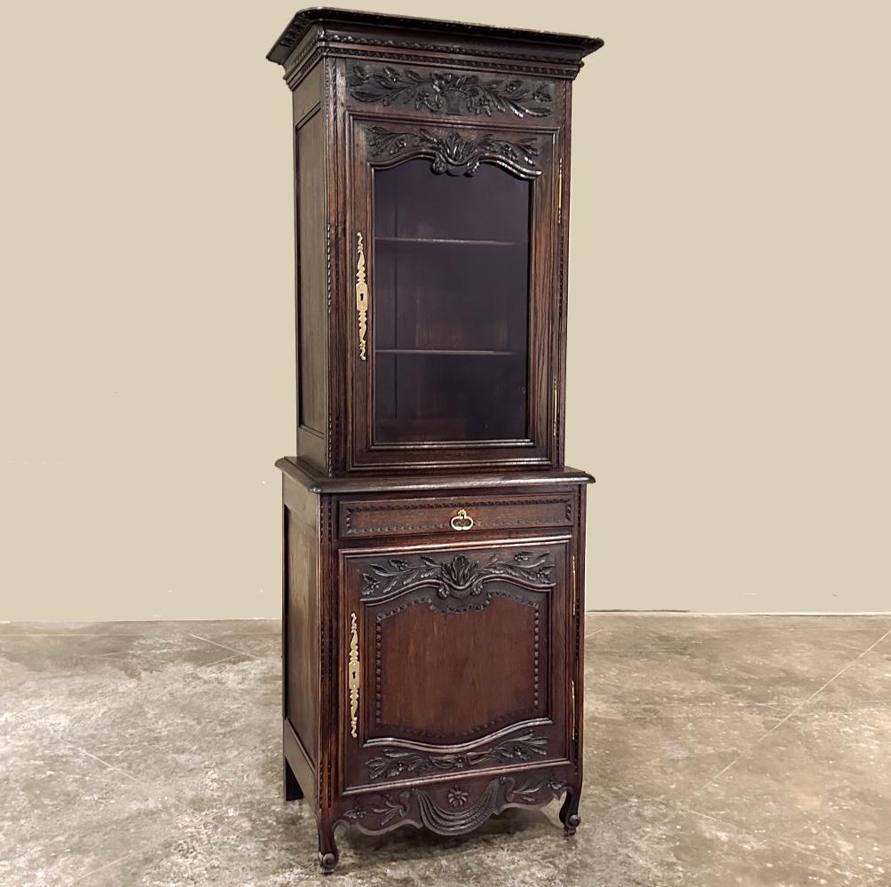 19th Century Country French Two-Tiered Vitrine is a marvel of the furniture maker's art!  Hand-crafted from dense, old-growth oak, hand-rolled glass and hand-forged brass, it harks back to an era when traditional artisans passed down techniques and