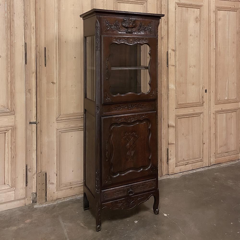 19th century Country French Vitrine ~ Bonnetiere from Normandie is in essence a petite display armoire that is more versatile for efficient floor plans! Hand-crafted from solid indigenous old-growth oak, it features a finely molded crown centered