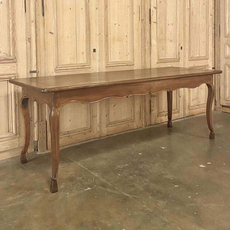 19th century country French walnut dining table is a superb example of rural artisanry! Utilizing indigenous, sumptuous walnut, the craftsmen employed double pegged mortise and tenon joinery, a technique handed down for centuries by French