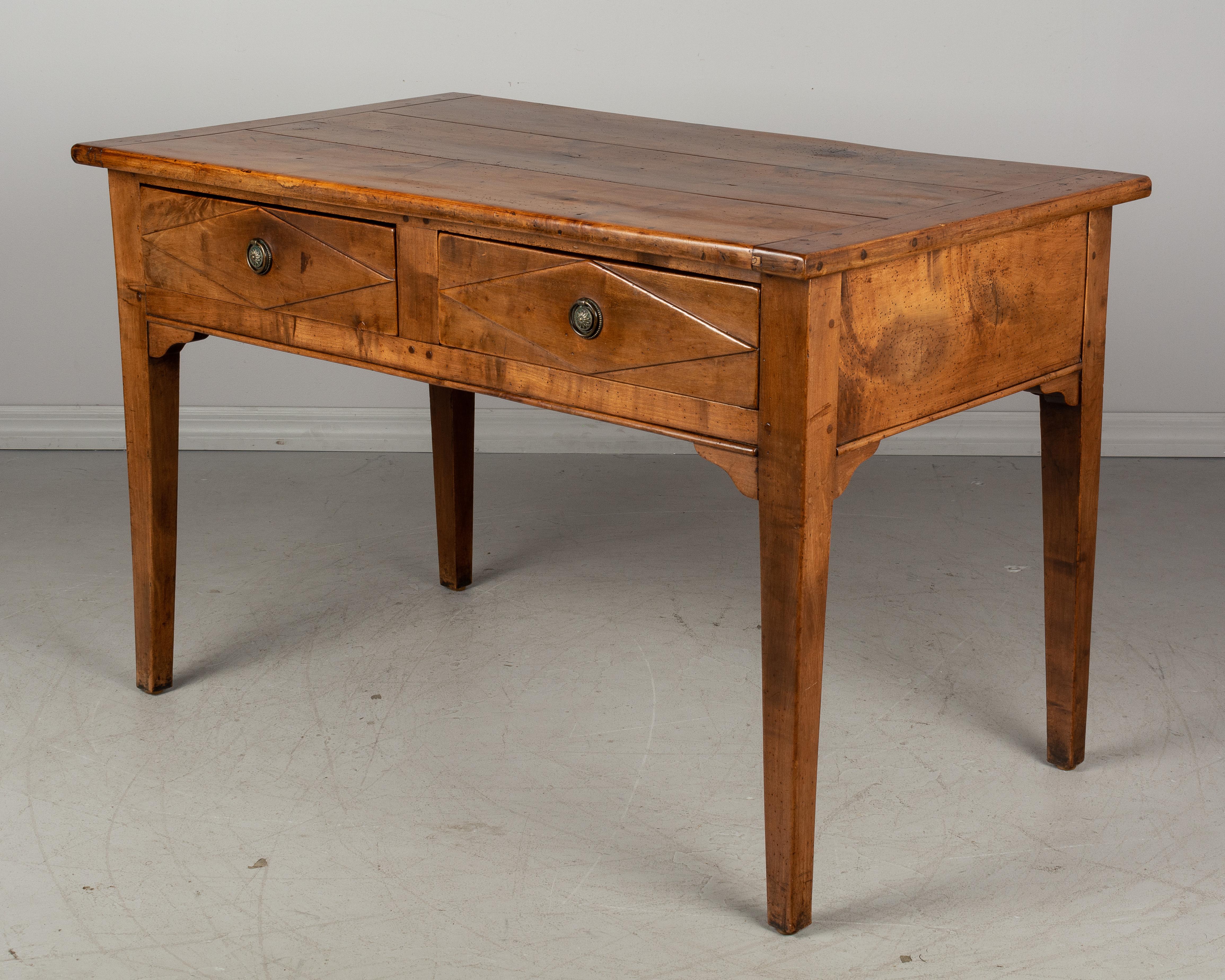 A 19th century Country French walnut farm table with two large, deep dovetailed drawers. Original brass ring pulls. A good solid table, well-crafted of thick wood planks using pegged construction. May be used as a console or center table. Clearance