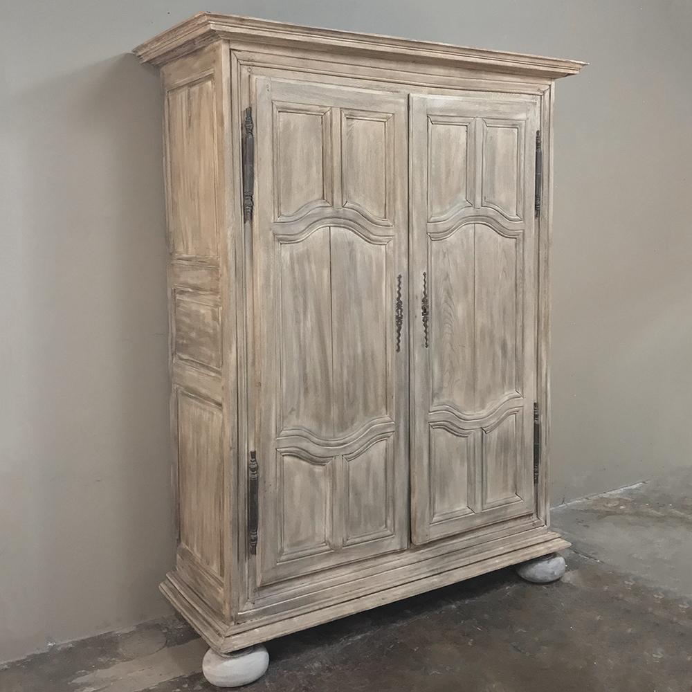 19th century Country French whitewashed armoire from Lorraine features tailored lines and handcrafted excellence designed to last a lucky family for generation after generation. Bold molding and contoured frameworks around the panels combine with