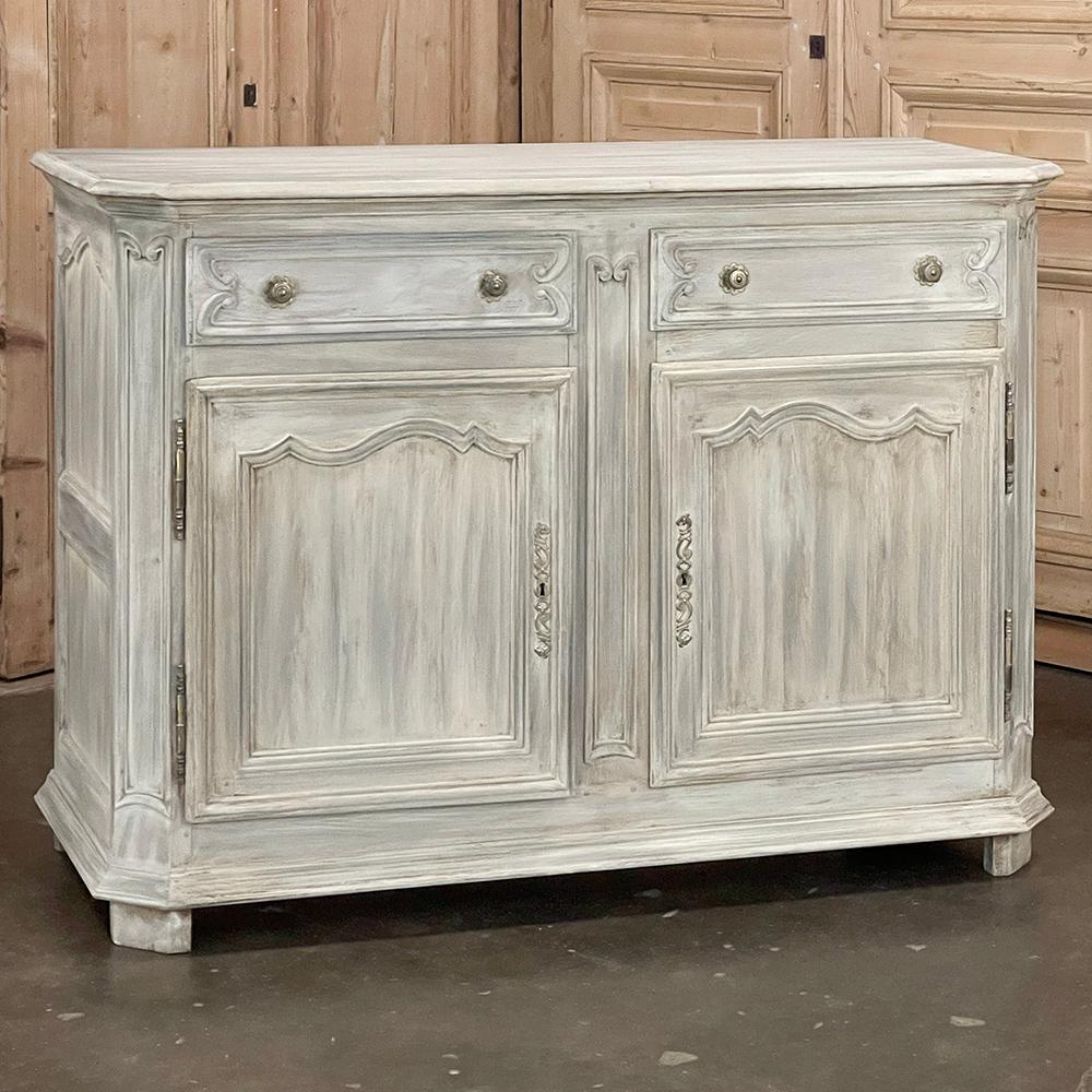 19th Century Country French Whitewashed Oak Buffet is a study in understated elegance!  The spacious top features fine molded detail and mitered corners for visual appeal as well as superior ergonomics.  Recessed panels on the sides include triple