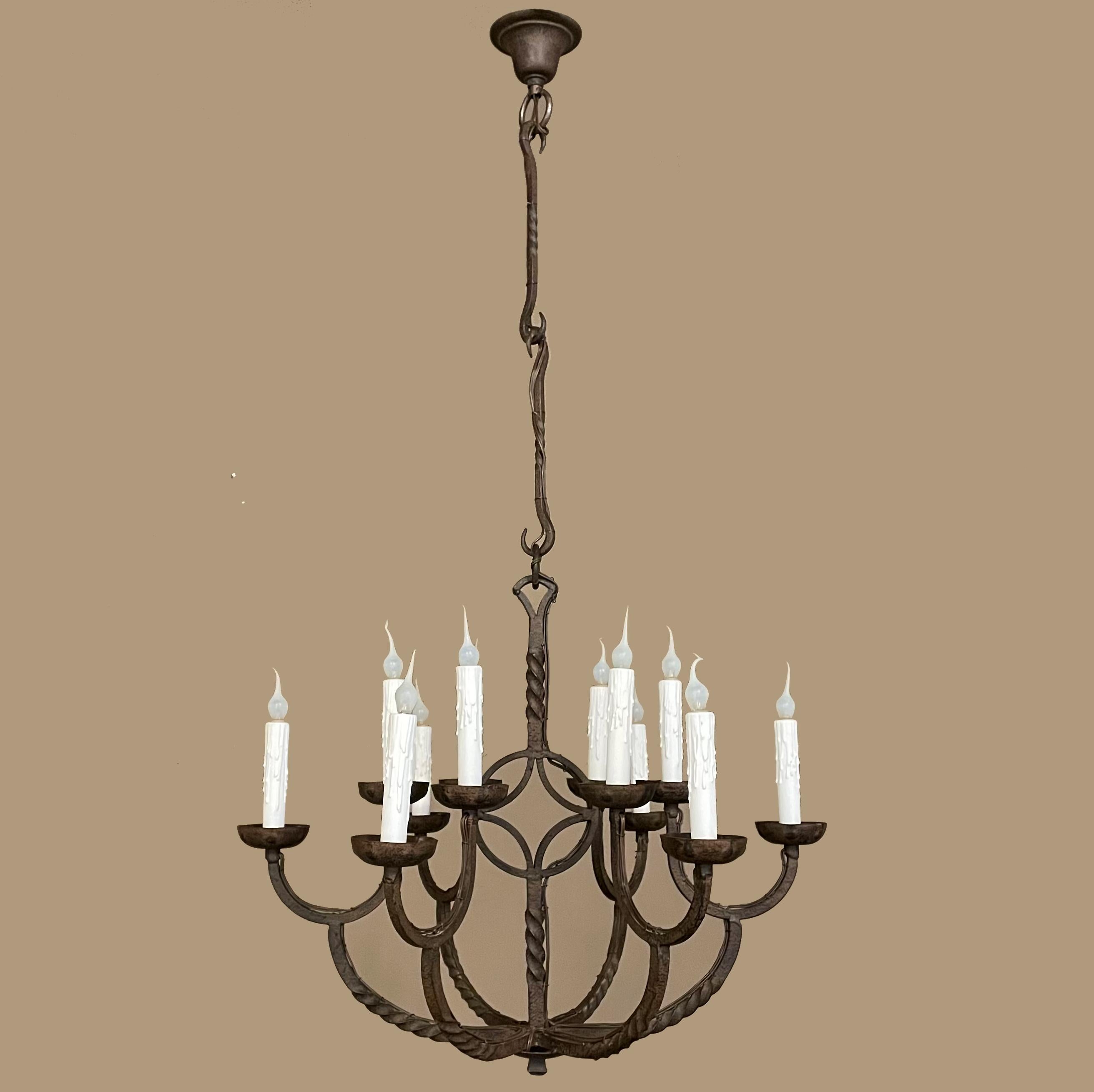 19th century Country French wrought iron chandelier was forged by a talented metalsmith out of red-hot iron and designed for candles. Newly electrified for 21st century enjoyment, it features craftsmanship and artistry to which new fixtures can't