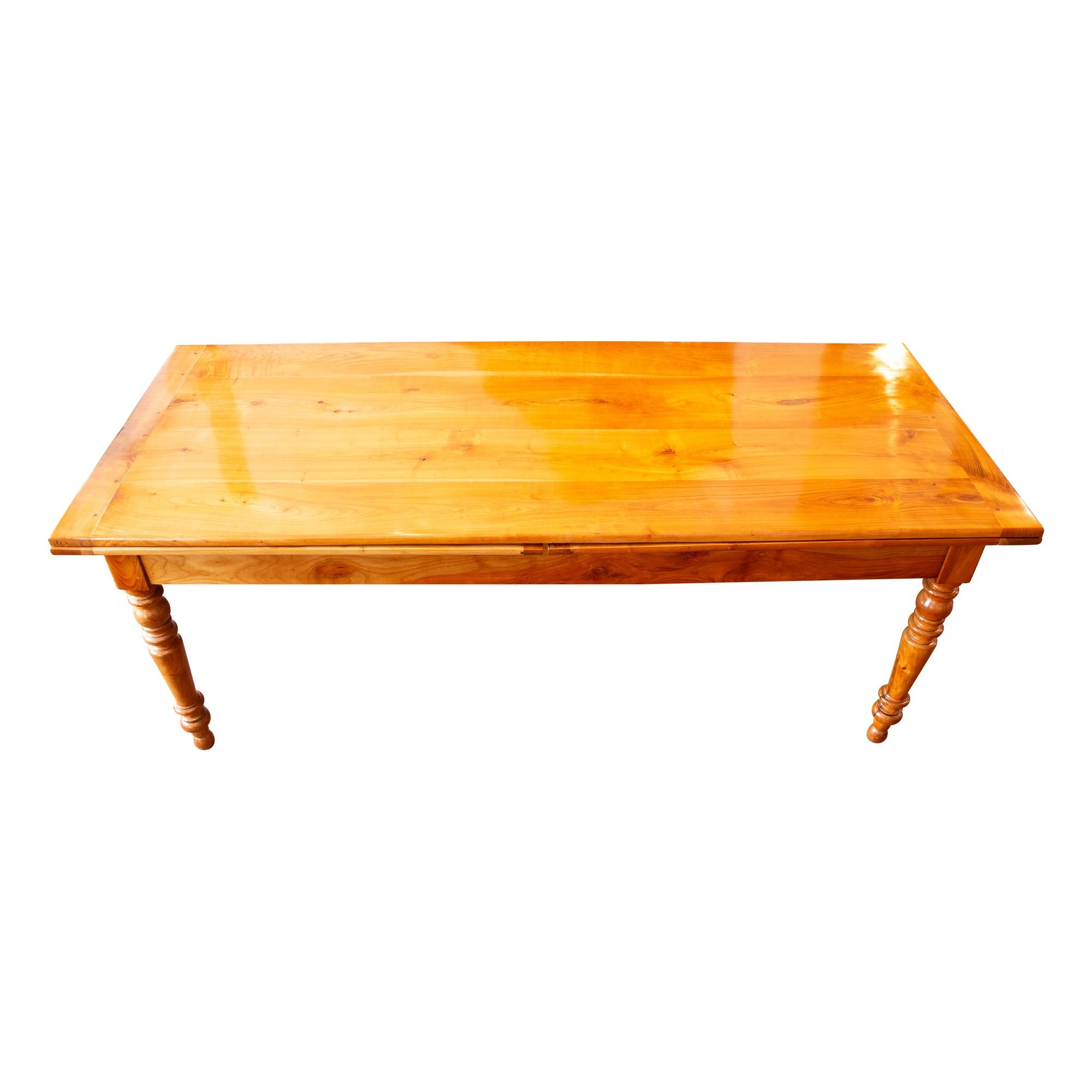 Introducing our exquisite offering: a remarkable country house table crafted from solid cherry wood, originating from the late Biedermeier period around 1850. This captivating piece boasts two cherry extendable tops, ensuring versatility and