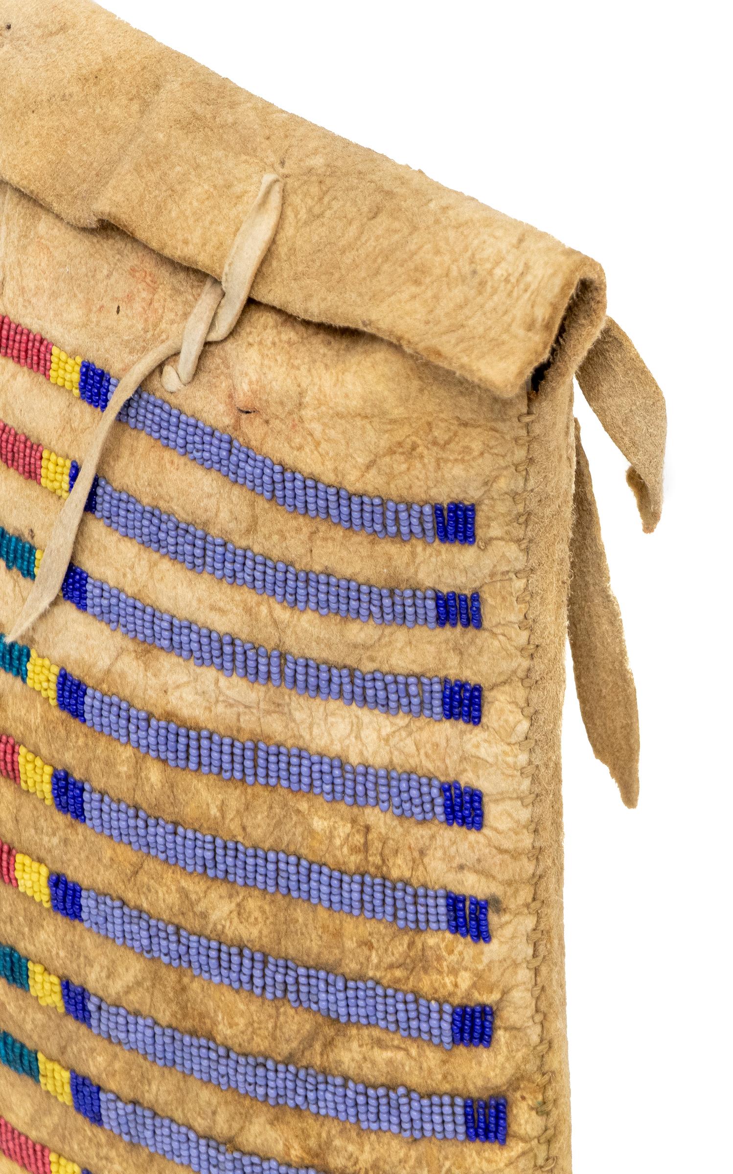 This exquisite 19th-century Crow (Plains Indian) beaded Tepee bag, dating from circa 1860-1875, is a rare and authentic example of Native American artistry. The bag is expertly constructed from native tanned buffalo hide, known for its strength and