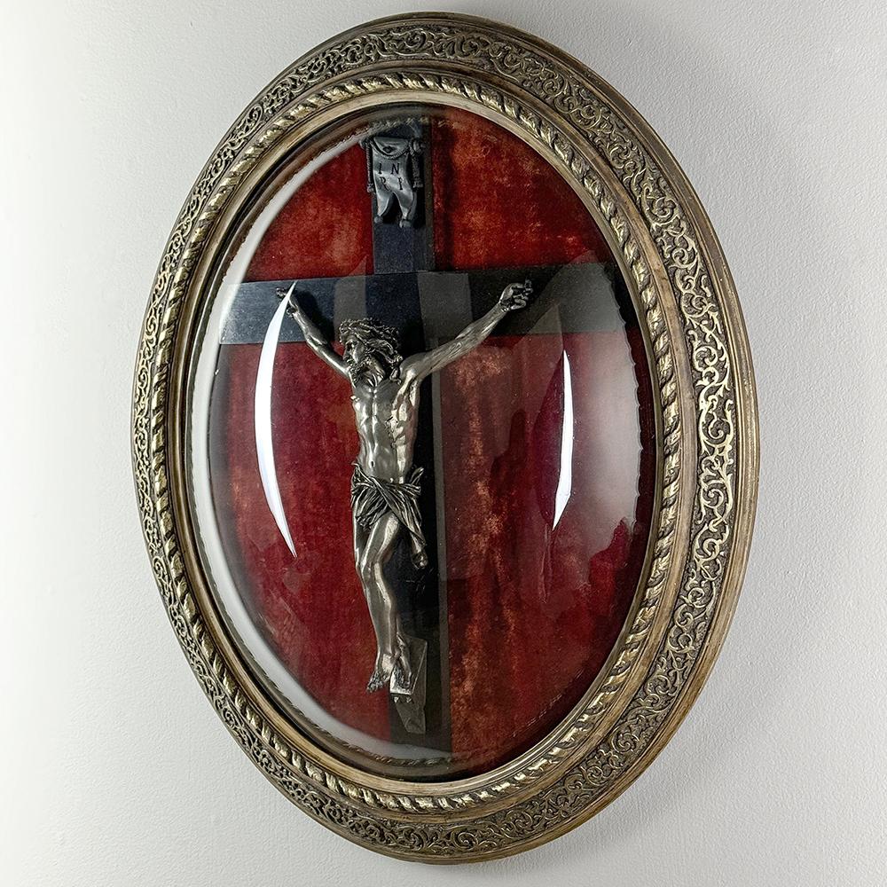 19th Century Crucifix in Oval Giltwood Frame with Glass is remarkably well preserved, and perfect for a devotional addition to your home.  The dark stained cross provides a nice contrast to the pewter corpus which exhibits extraordinary detail, all