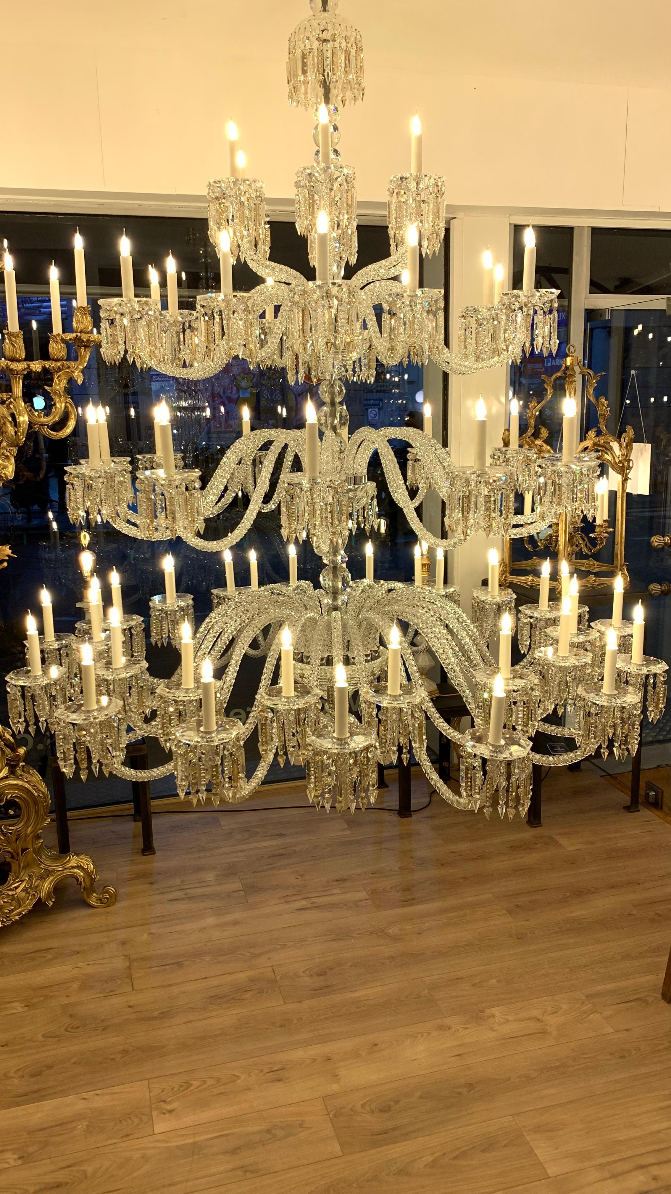 This very large and majestic chandelier is made of solid and hand cut crystal. 
It is divided into three floors. The arms of lights are in twisted glasses. The central barrel is in chromed metal covered by crystal parts.

We have one chandelier in