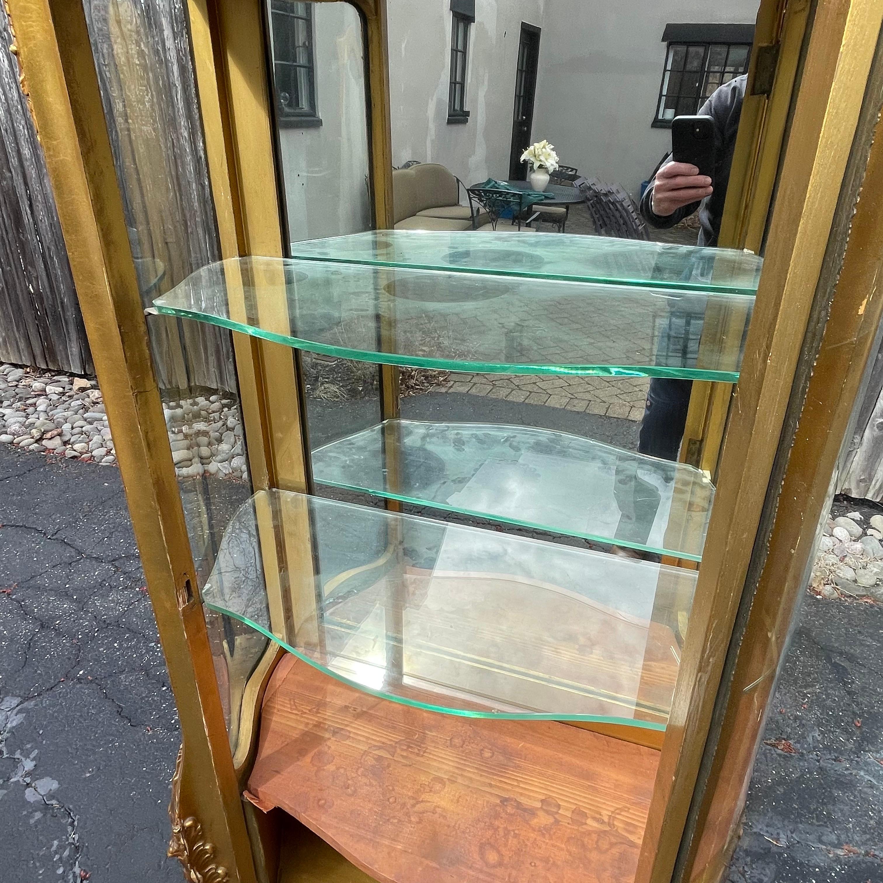 Beautiful late 19th century gold vitrine with curved glass, France.