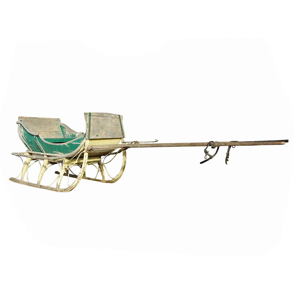 Perfectly weathered green and white paint adds just the right touch of color to the silvery wood frame of this festive beauty. A painted “1800” adorns the back of the sleigh, which retains its original shafts.