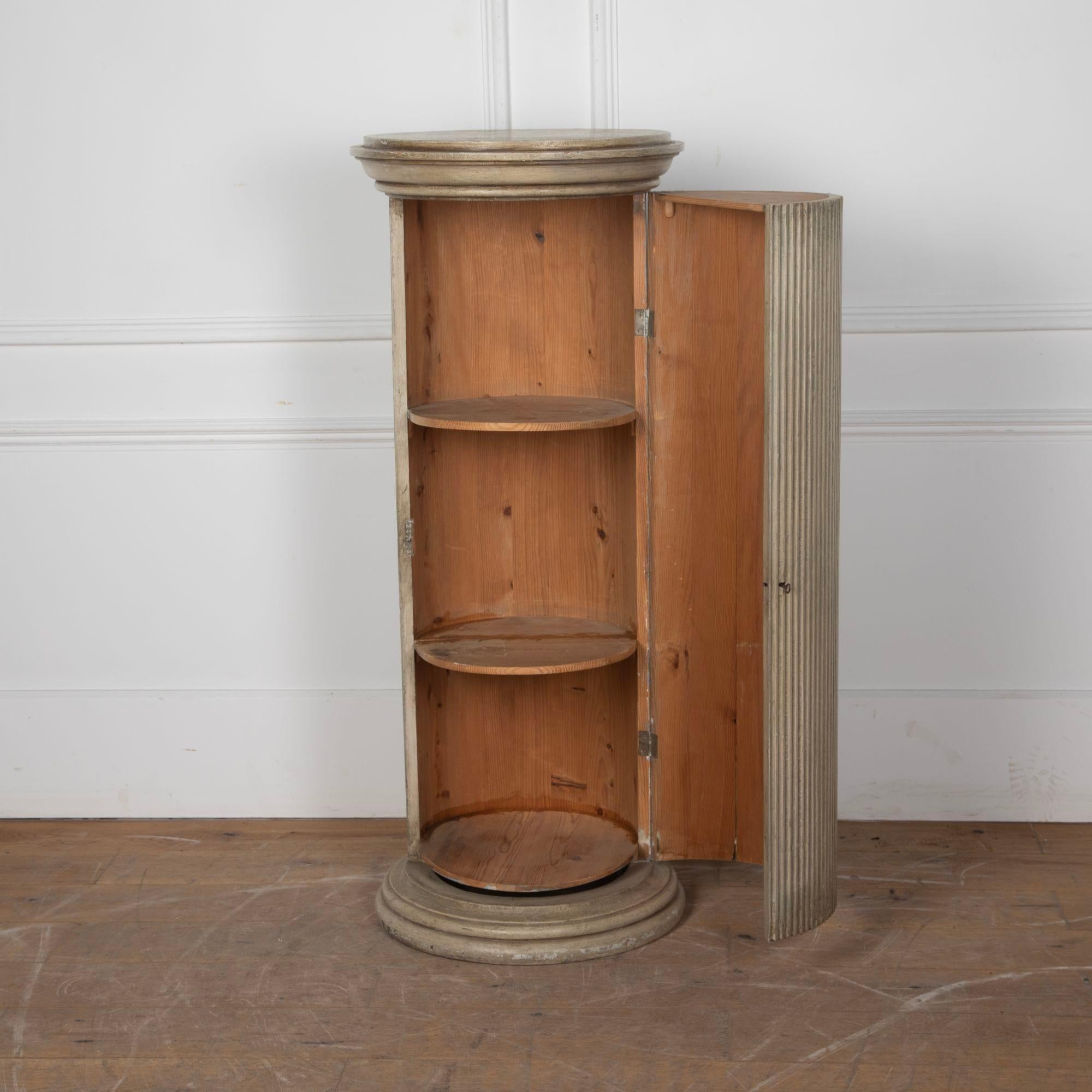 Early 19th Century Swedish Gustavian period cylindrical column cabinet. This cabinet is in a reeded painted pine decoration. The column opens to reveal shelves retaining their original lock and key. Perfect for use as a cocktail cabinet.